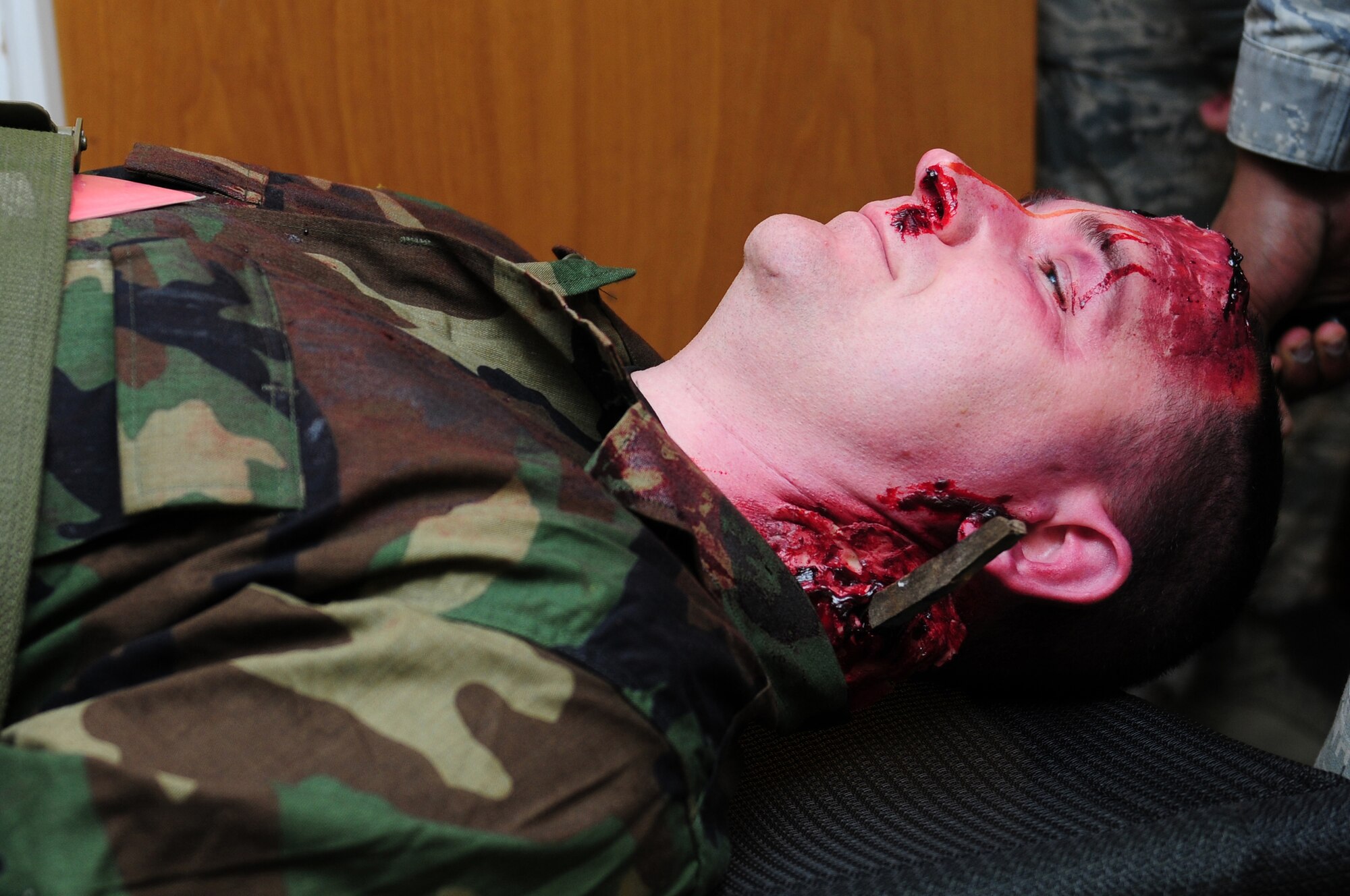 ROYAL AIR FORCE LAKENHEATH, England - Tech. Sgt. Robert Vittore, 48th Force Support Squadron manpower analyst, is littered into a hardened facility after sustaining injuries from a simulated attack during the NATO Tactical Evaluation, Dec. 15, 2011. Moulage was used to make the training as realistic as possible to better prepare the Airmen for real world scenarios. The exercise measured the 48th Fighter Wing's ability to respond to a contingency situation.  (U.S. Air Force photo by Senior Airman Lausanne Morgan)