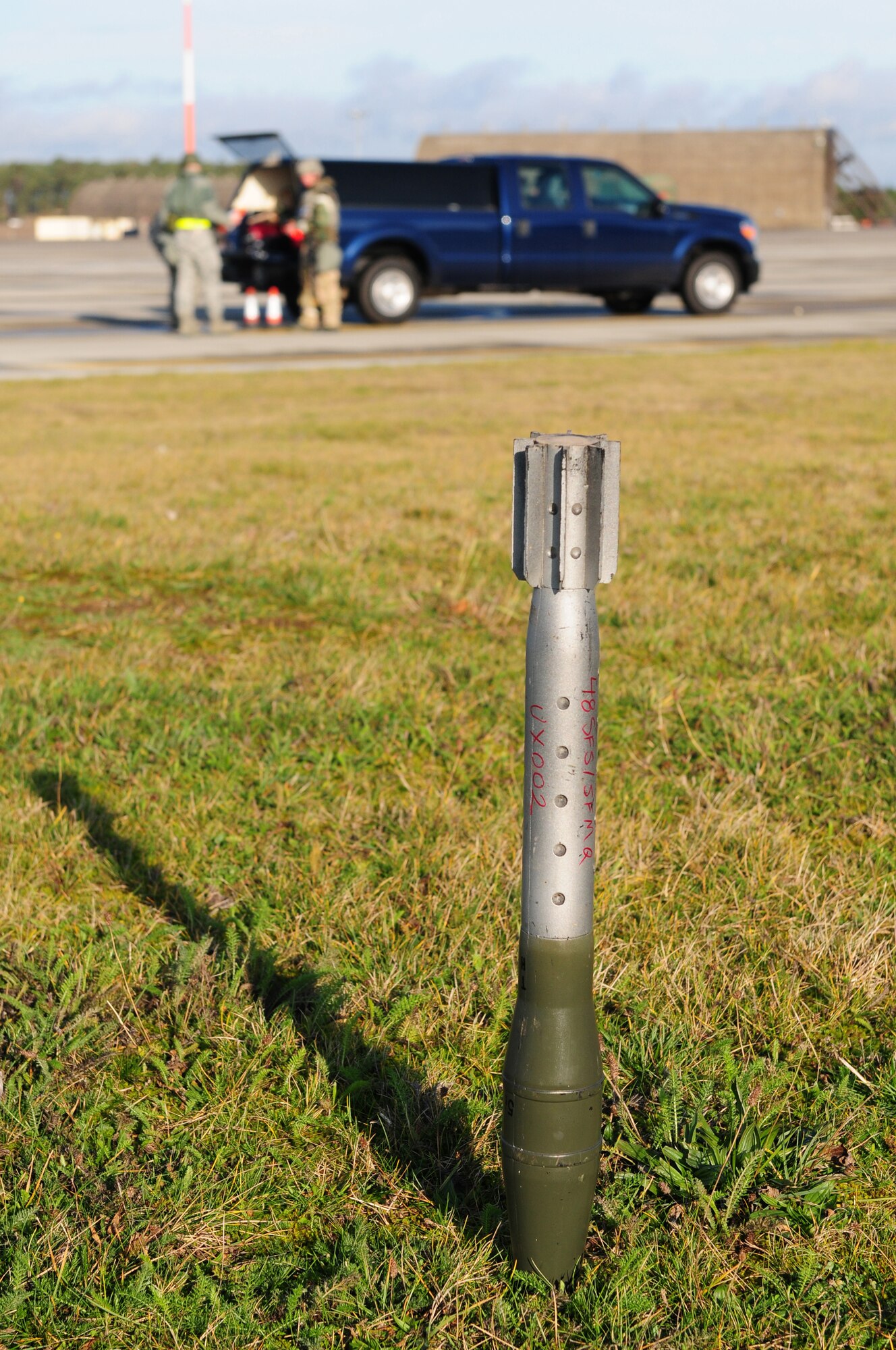 ROYAL AIR FORCE LAKENHEATH, England - A mock unexploded ordinance lands in a restricted area during the NATO Tactical Evaluation, Dec. 15, 2011. The exercise measured the 48th Fighter Wing's ability to respond to a contingency situation. (U.S. Air Force photo by Senior Airman Lausanne Morgan)