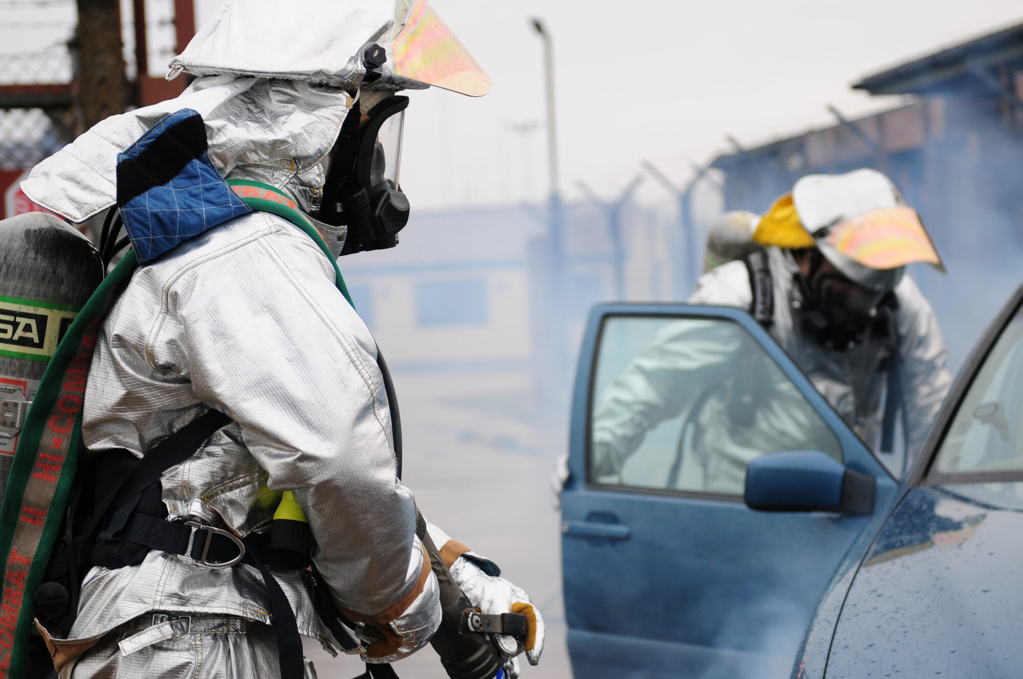 ROYAL AIR FORCE LAKENHEATH, England - Airman 1st Class Dustin Dawson (left) and Staff Sgt. Christopher Brown, 48th Civil Engineer Squadron firefighters, respond to a simulated vehicle collision during the NATO Tactical Evaluation, Dec. 15, 2011. The exercise measured the 48th Fighter Wing's ability to respond to a contingency situation. (U.S. Air Force photo by Senior Airman Lausanne Morgan)