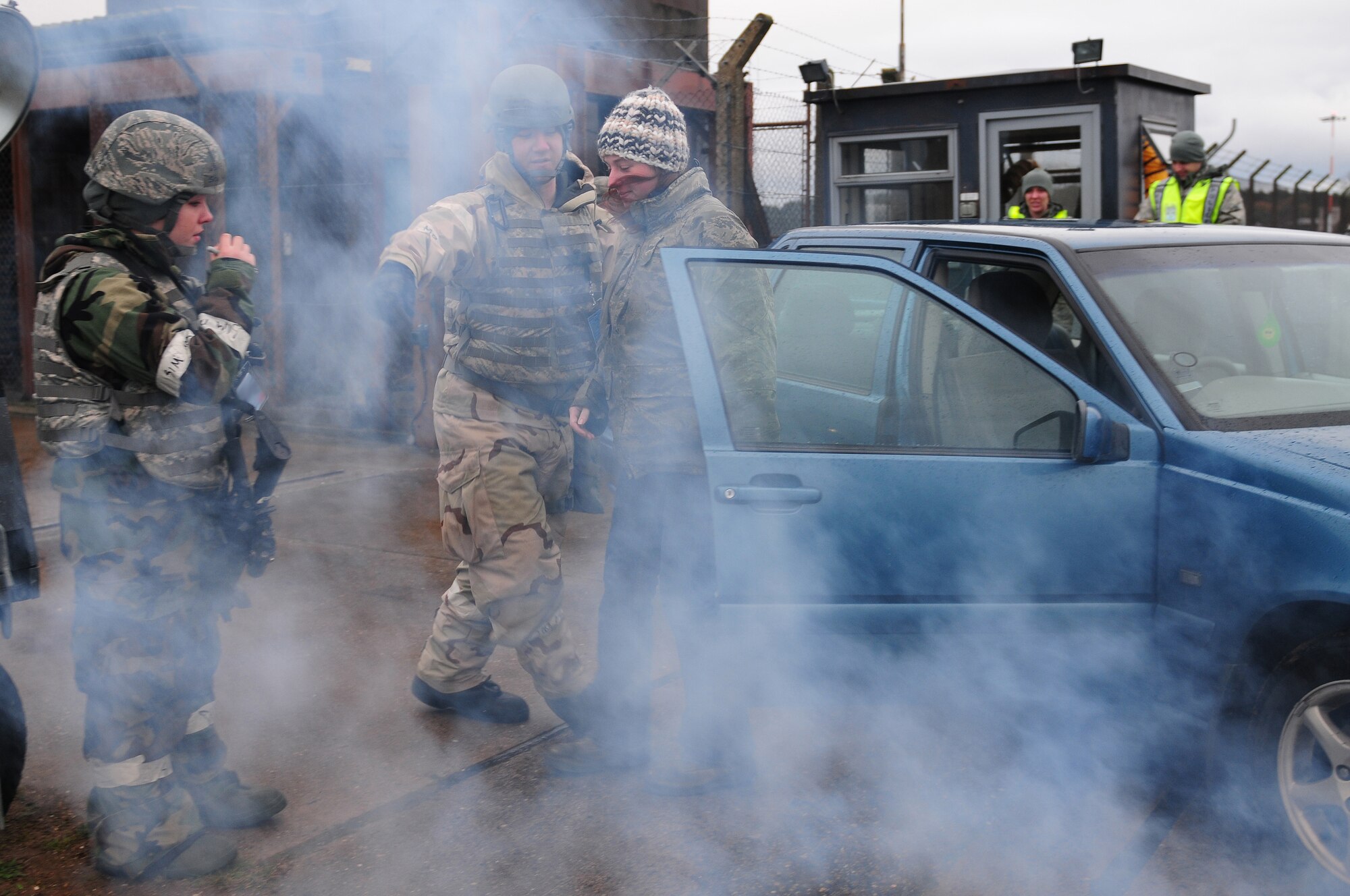 ROYAL AIR FORCE LAKENHEATH, England - Senior Airmen Anna Wilsey and Sean Gallant, 48th Security Forces Squadron patrolmen, assists a victim out of a simulated vehicle collision during the NATO Tactical Evaluation, Dec. 15, 2011. The exercise measured the 48th Fighter Wing's ability to respond to a contingency situation. (U.S. Air Force photo by Senior Airman Lausanne Morgan)