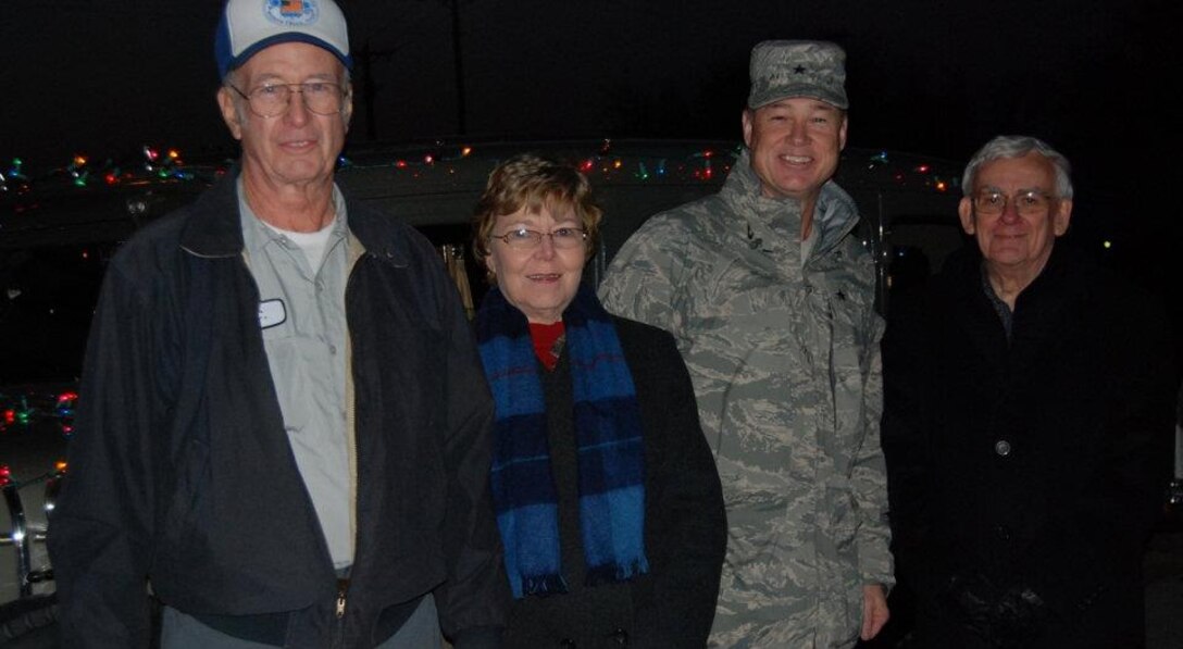 Brig. Gen. Darryl Burke, Sheppard Air Force Base commander, braves 37-degree temperatures with Burkburnett City Mayor Carl Law and his wife, Eloise, Dec. 9 for the annual Lighted Christmas Parade. Mr. C.C. Corbin, a veteran, donates and drives his Model-T Ford as the lead car in the Burkburnett parade each year for the base commander. (U.S. Air Force photo/Debi Smith)