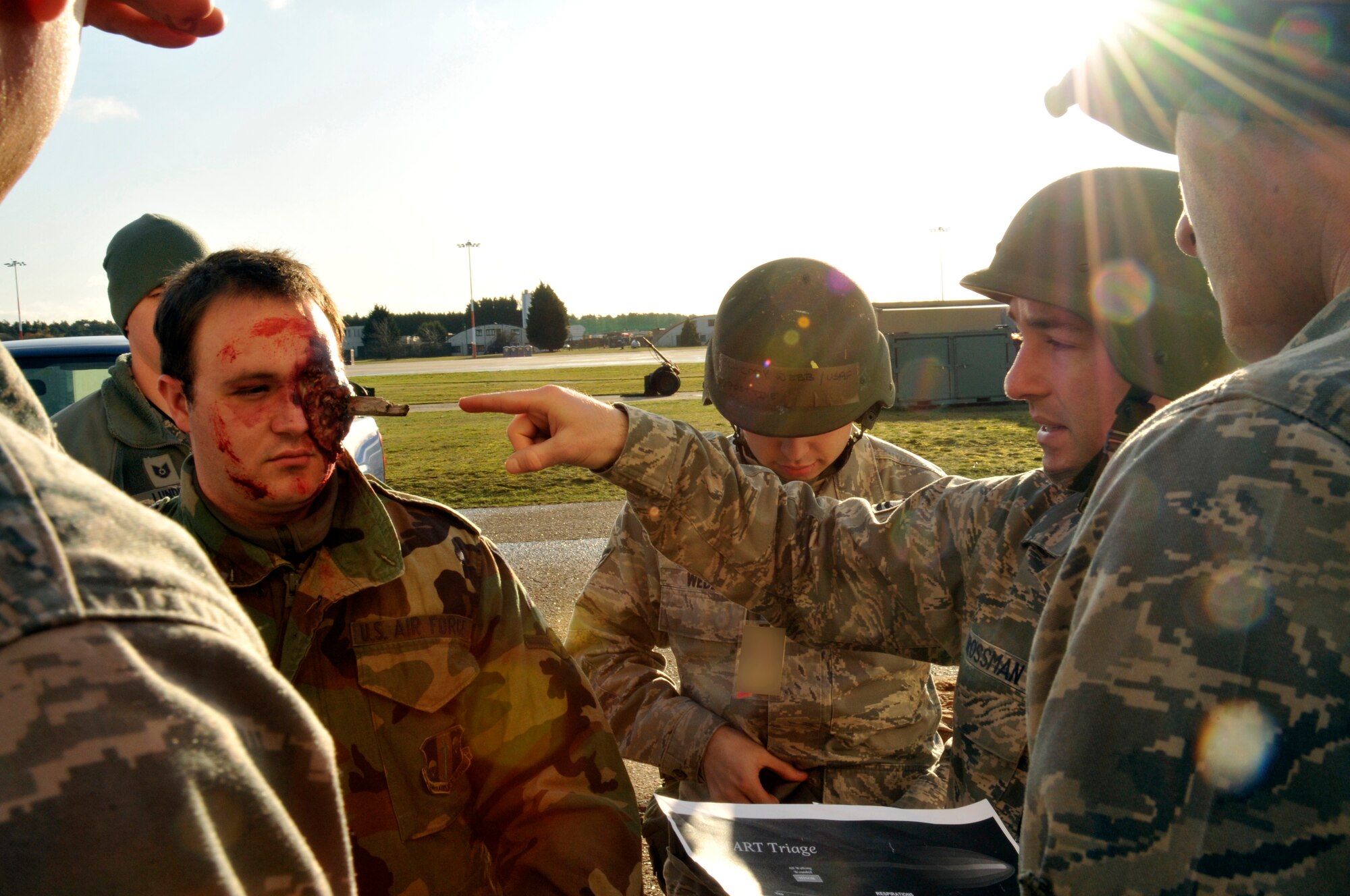 ROYAL AIR FORCE LAKENHEATH, England - Tech. Sgt. Jason Grossman describes a simulated injury to Staff Sgt. Christopher Kettle during the NATO Tactical Evaluation, Dec. 15, 2011. The exercise measured the 48th Fighter Wing's ability to respond to a contingency situation. (U.S. Air Force photo by Staff Sgt. David Dobrydney)