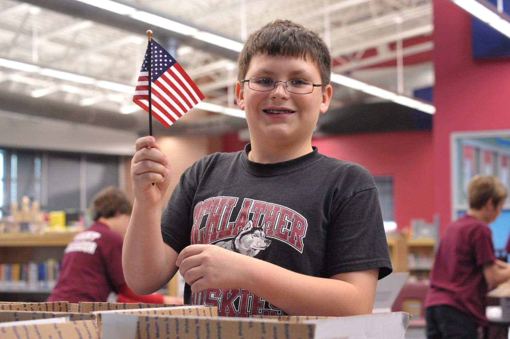 Carter Arispe, Schlather Intermediate School sixth-grader, waves an American flag while participating in Operation Shoebox Dec 9. The students sent care package to deployed Joint Base San Antonio servicemembers over the holidays.
(U.S. Air Force photo by Airman 1st Class Alexis Siekert)