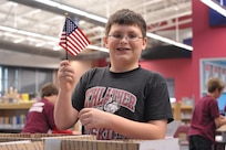 Carter Arispe, Schlather Intermediate School sixth-grader, waves an American flag while participating in Operation Shoebox Dec 9. The students sent care package to deployed Joint Base San Antonio servicemembers over the holidays.
(U.S. Air Force photo by Airman 1st Class Alexis Siekert)