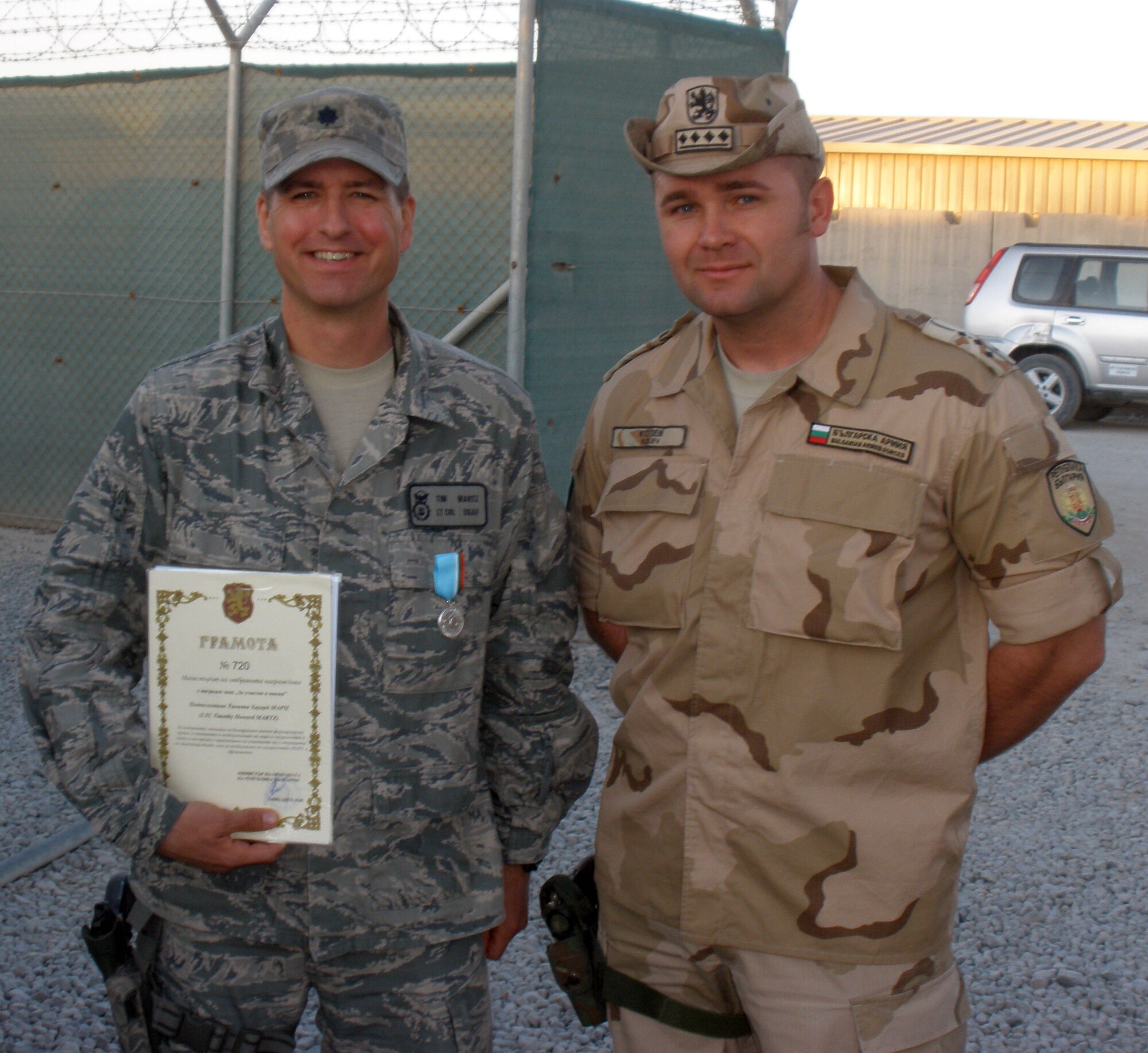 Lt. Col. Timothy Martz poses with a Bulgarian captain after being presented a Bulgarian Medal at Kandahar Airfield. While deployed, Martz was also awarded the Bronze Star Medal for Meritorious Service. (U.S. Air Force photo/ Senior Airman Danielle Purnell)