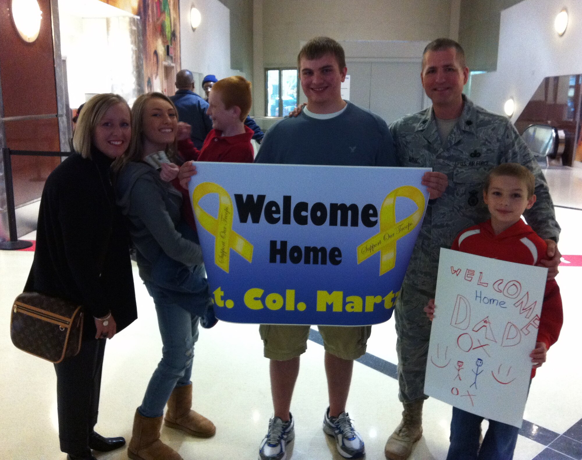 Lt. Col. Timothy Martz poses with his wife, Heidi, daughter, Sasha, and sons Johnny, Jake and Jack at the Harsfield-Jackson Airport in Atlanta in November. Martz was returning from a deployment to Kandahar, Afghanistan where he was awarded the Bronze Star medal for Meritorious Service. (U.S. Air Force photo/ Senior Airman Danielle Purnell)