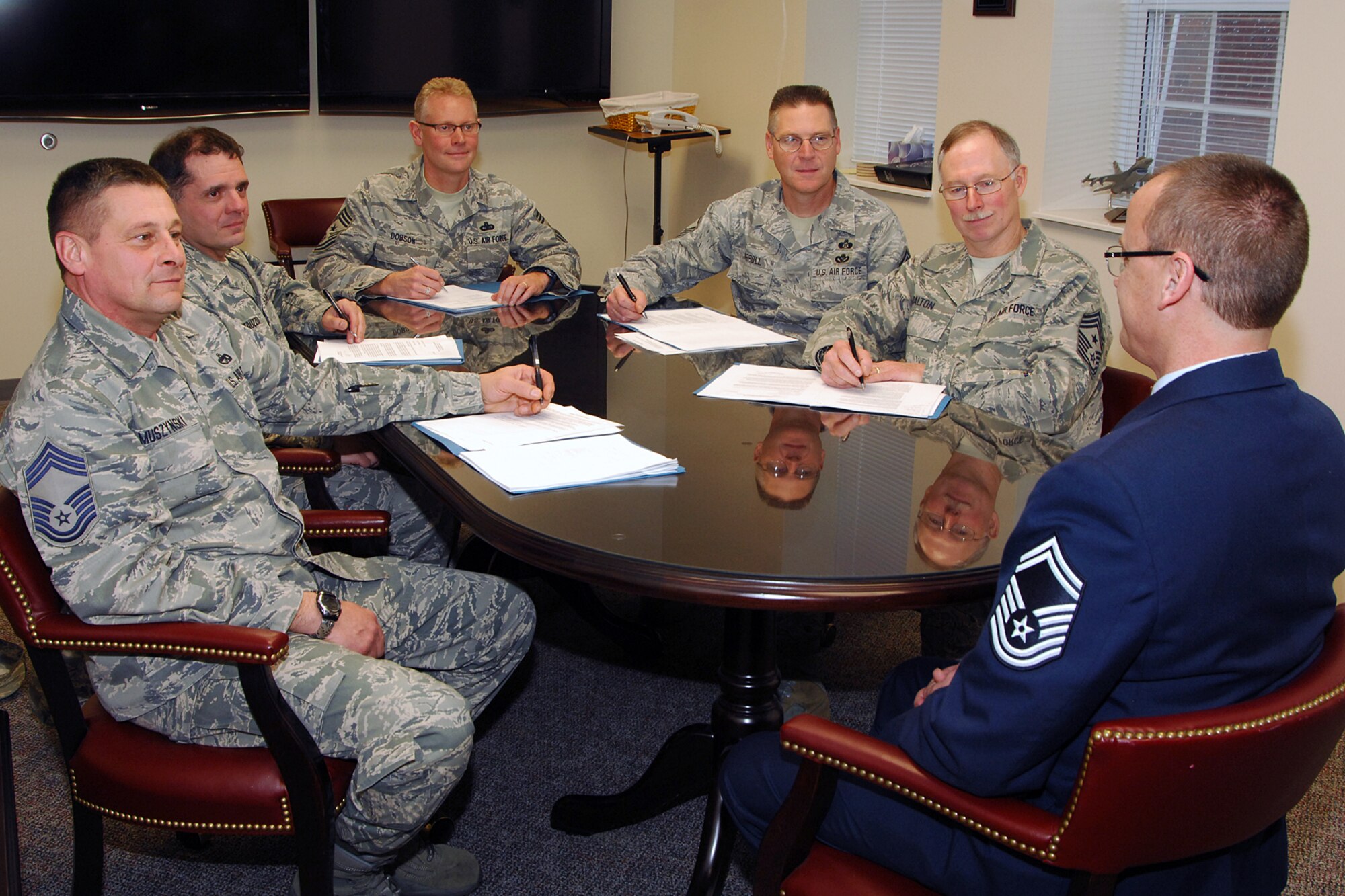Senior Master Sgt. Jim Hart, 191st Maintenance Squadron, meets with a promotion board at Selfridge Air National Guard Base, Dec. 14, 2011. Hart met with the board as a candidate for promotion to chief master sergeant, the highest enlisted rank in the U.S. Air Force. Making up the board are (from left) Chief Master Sgt. Terry Muszynski, 127th Logistics Readiness Squadron; Chief Master Sgt. Gary Fantauzzo, 127th Force Support Squadron; Chief Master Sgt. Robert Dobson, 127th Wing command chief; and Chief Master Sgt. Mike Carroll, 127th Civil Engineer Squadron. Also sitting in as an observer was Chief Master Sgt. Mike Dalton, command chief for the Michigan Air National Guard. Hart said he studied the “Little Brown Book” – Air Force Instruction 36-2618 “The Enlisted Force Structure” – to prepare for his meeting with the board. (U.S. Air Force photo by John S. Swanson)