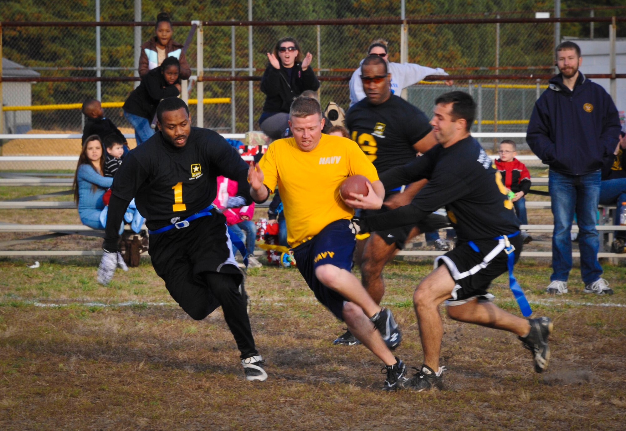 Tom Lego scrambles up the middle of the Army’s defense on his way to a 40-yard run during the annual Army vs. Navy flag football game Nov. 3 here. Players from the Army’s Mid-Atlantic Recruiting Battalion named Lego as the recipient of the Sportsmanship Award for his efforts during the game. The Soldiers claimed their third consecutive win over the Sailors from Naval Support Activity-Lakehurst, coming back to win 20-13. (U.S. Air Force photo by Airman 1st Class Bryan Swink/Released) 
