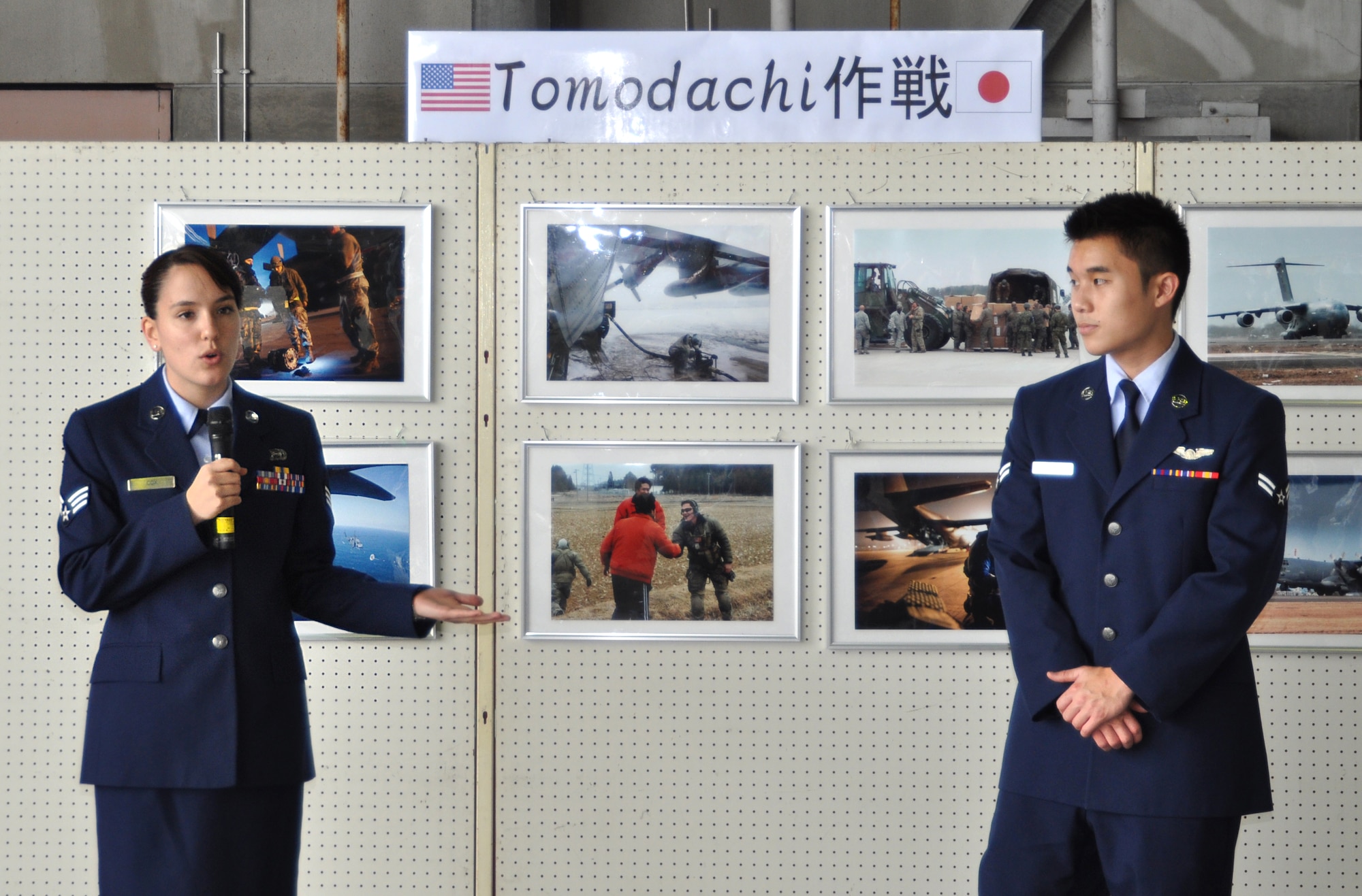U.S. Air Force Senior Airman Veronica Cox, intelligence analyst, and Airman
1st Class Takashi Yoshino, aerial gunner, both from the 33rd Rescue
Squadron, brief Okinawa locals in Japanese about their participation in
Operation Tomodachi humanitarian relief efforts at the Japan Air Self
Defense Force annual Air Fest at Naha Air Base, Okinawa, Japan, Dec. 11,
2011. Cox and Yoshino were chosen to speak about their personal experiences
and what their squadron did to provide support for mainland Japan after it
was affected by a massive earthquake and tsunami in March 2011. (Courtesy
photo by 5th Air Defense Missile Group Cameraman Capt. Masahide
Tanaka/Released)
