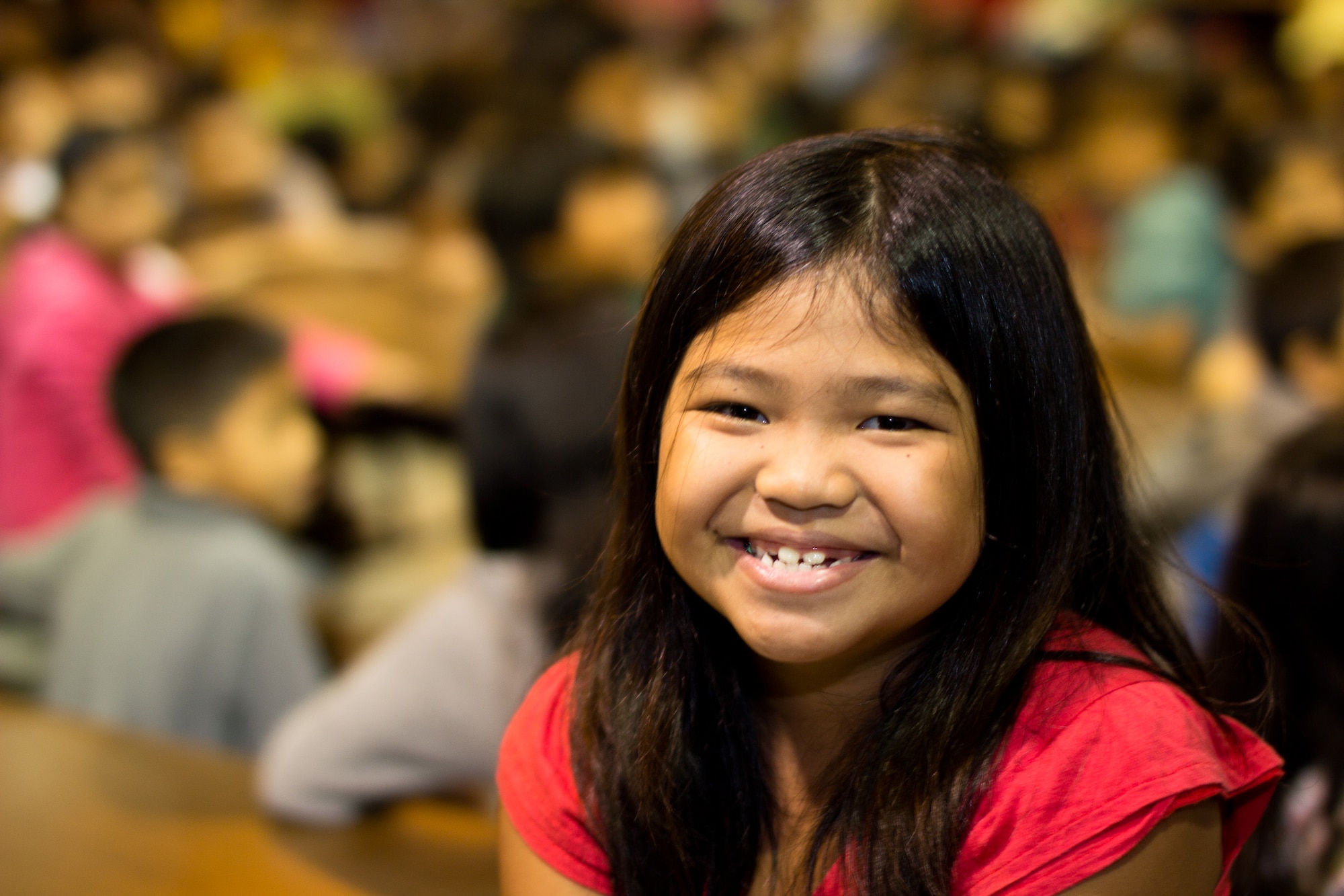 YIGO VILLAGE, Guam -- A Machanano Elementry School student smiles during Band of the Pacific-Asia Pacific Trends performance at the Machanano Elementary School, Yigo Village, Guam, Dec. 13, 2011. Many students smiled the entire show. (U.S. Air force photo/Staff Sgt. Josh Voyles)