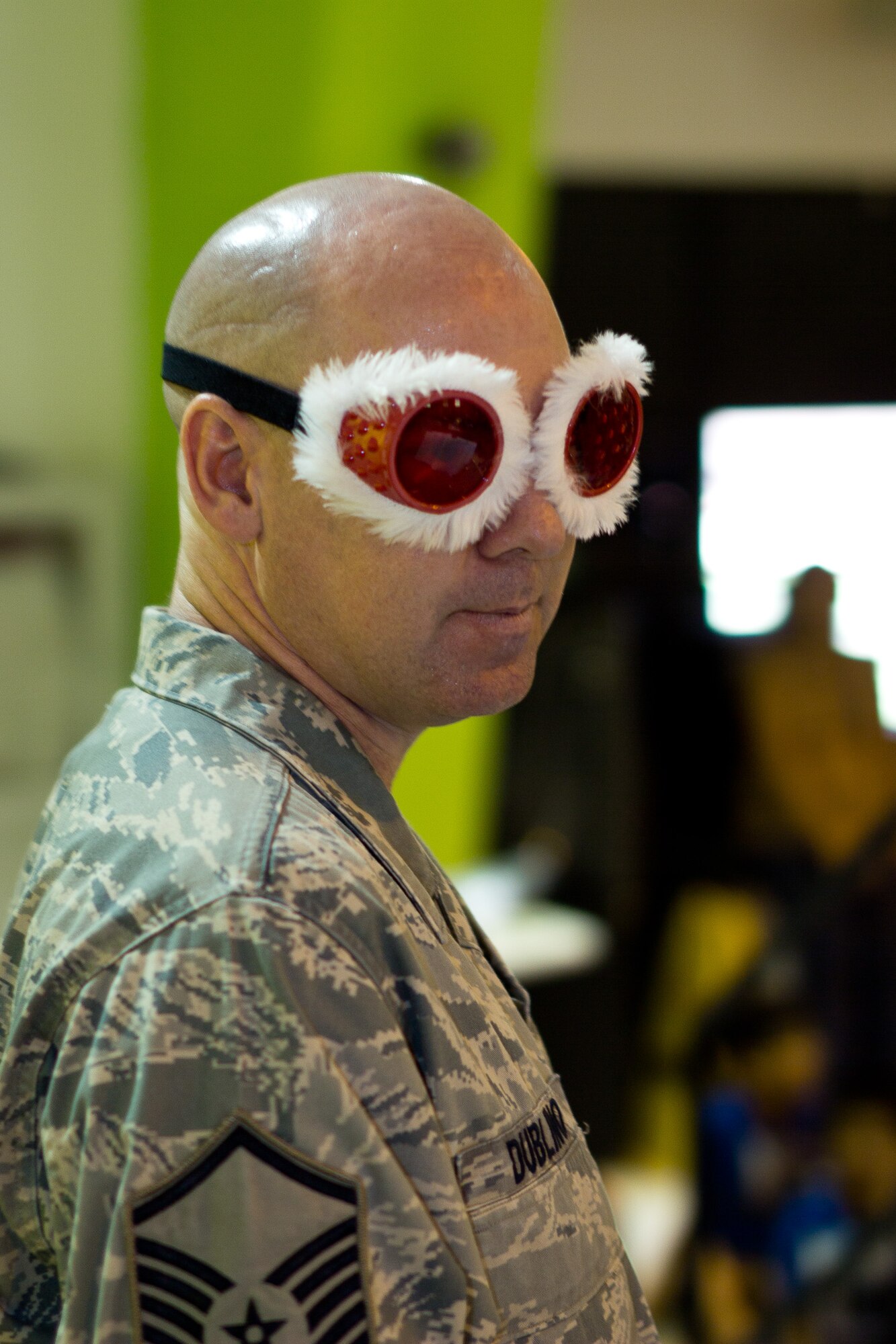 YIGO VILLAGE, Guam -- Master Sgt. Vincent Dublino, Band of the Pacific-Asia keyboardist, glances to the side while sporting "Santa glasses" during a performance at the Machanano Elementary School, Yigo Village, Guam, Dec. 13, 2011. Dublino used props such as these glasses to make the performance more entertaining for the children in the audience. (U.S. Air Force photo/Staff Sgt. Josh Voyles)