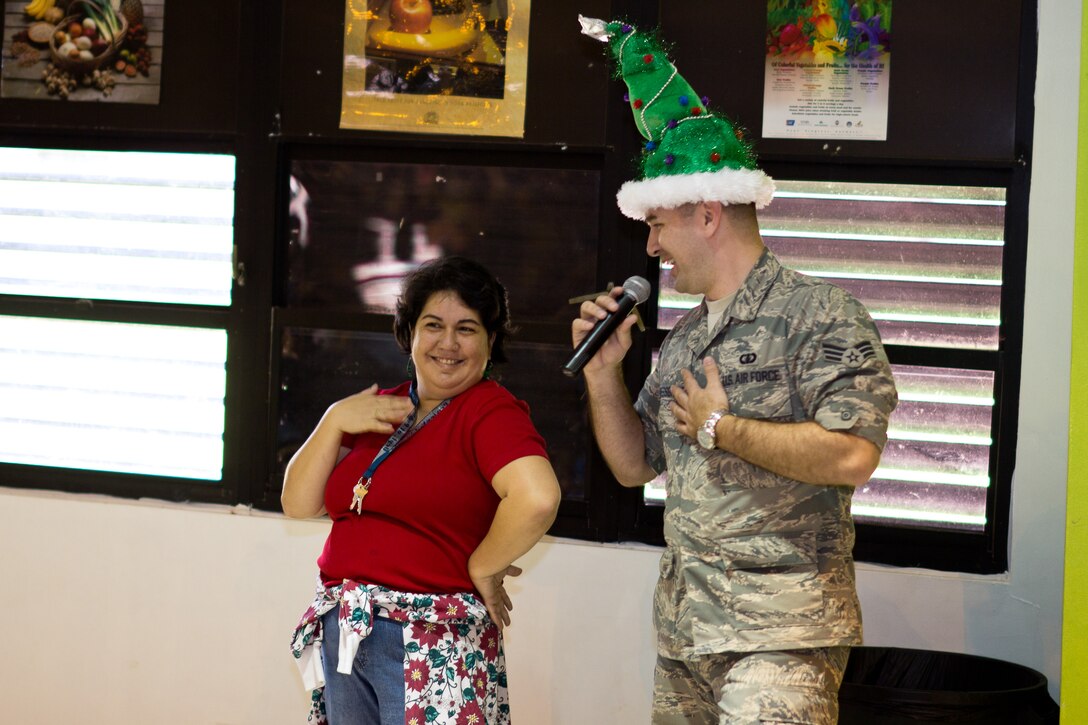 YIGO VILLAGE, Guam -- Senior Airman William Pressgrove, Band of the Pacific-Asia vocalist, sings Elvis Presely's "Blue Christmas" to Kim Edusma at the Machanano Elementary School, Yigo Village, Guam, Dec. 13, 2011. Pressgrove regularly sings to audience members while singing "Blue Christmas." (U.S. Air Force photo/Staff Sgt. Josh Voyles)