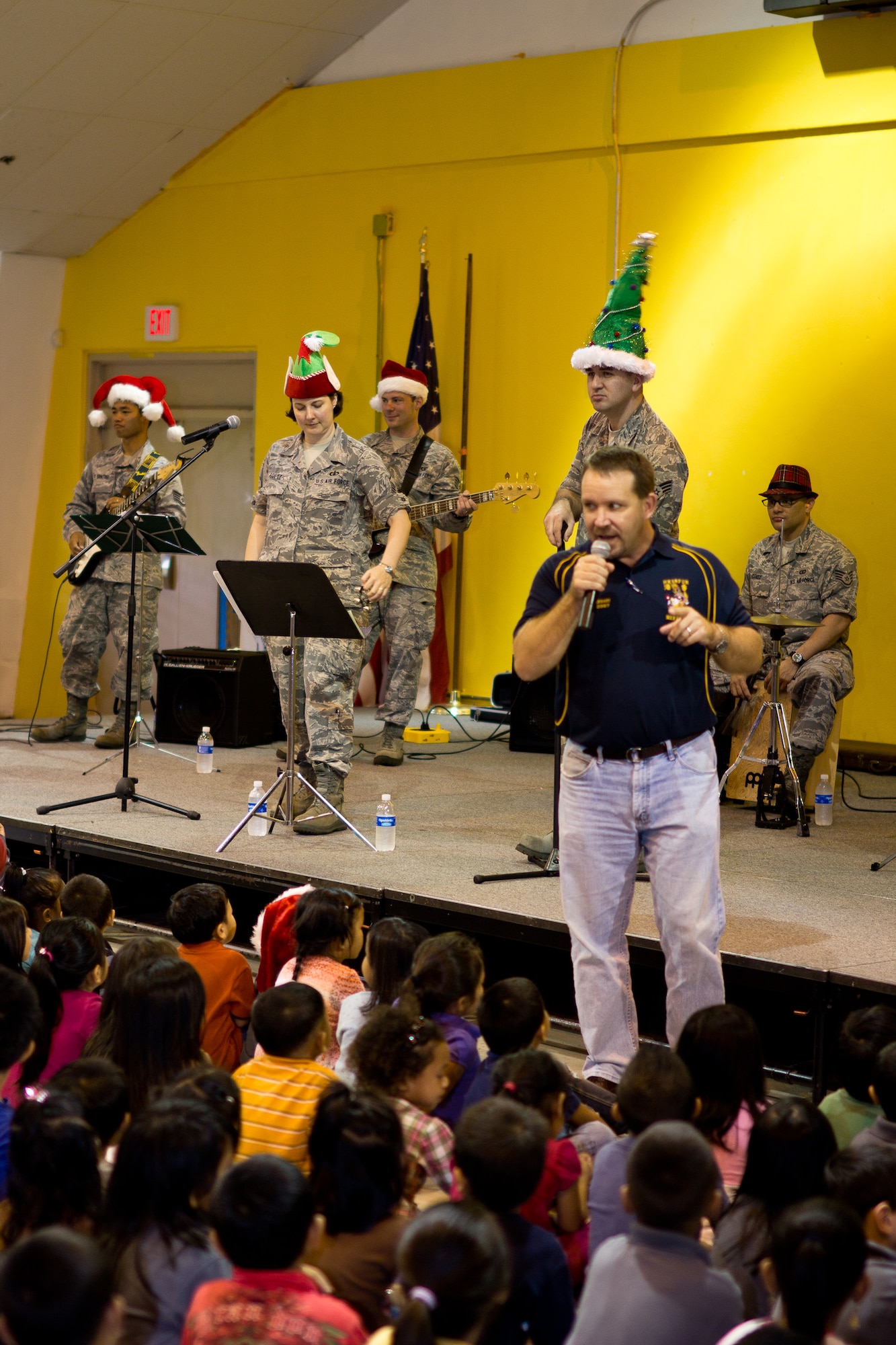 YIGO VILLAGE, Guam -- Robert Malay, Machanano Elementary School principal, introduces Band of the Pacific-Asia ensemble, Pacific Trends, prior to their performance at the Machanano Elementary School, Yigo Village, Guam, Dec. 13, 2011. Malay complimented the band following the show. (U.S. Air Force photo/Staff Sgt. Josh Voyles)