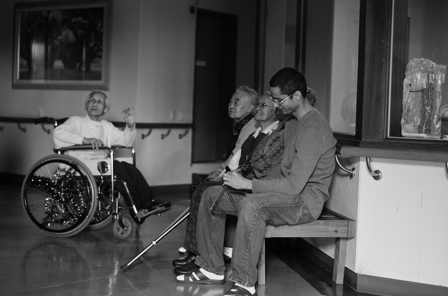 A member of the Wolf Pack spends time with residents of the Heart of Jesus Senior Care elderly home during his visit there for a Christmas celebration in Gunsan City, Republic of Korea, Dec. 10, 2011. The senior center was host to many smiles, cake, joint decorating and singing classic Christmas carols. (U.S. Air Force photo by Senior Airman Derrick Schwieters/Released)