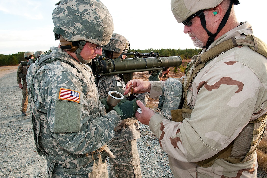 A civilian instructor loads a tracer training round into a Carl Gustav M3 84mm recoilless rifle during a certification course for paratroopers on Fort Bragg, N.C., Dec. 6, 2011. Though it only fires a 7.62mm tracer, the training modules look and feel similar to the actual projectiles that can be fired from the weapon.