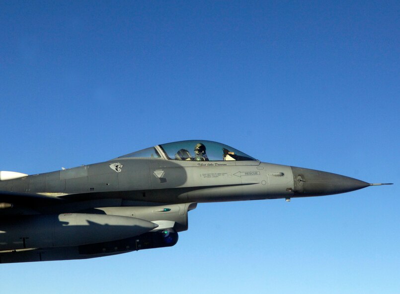 A F-16 from the 140th Fighter Wing, Buckley Air National Guard Base, CO, guides a C-21 from the 458th Airlift Squadron, Scott Air Force base, Ill Dec. 13 during Felix 12-4, a Western Air Defense Sector exercise.  The short notice exercise involved two scenarios, one where the two C-21 pilots were unconscious and another where the plane had been hijacked with no radio contact. In both scenarios the F-16 intercepted the C-21 over Colorado to guide them home. (U.S. Air Force photo/ Airman 1st Class Jacob Eckhardt)