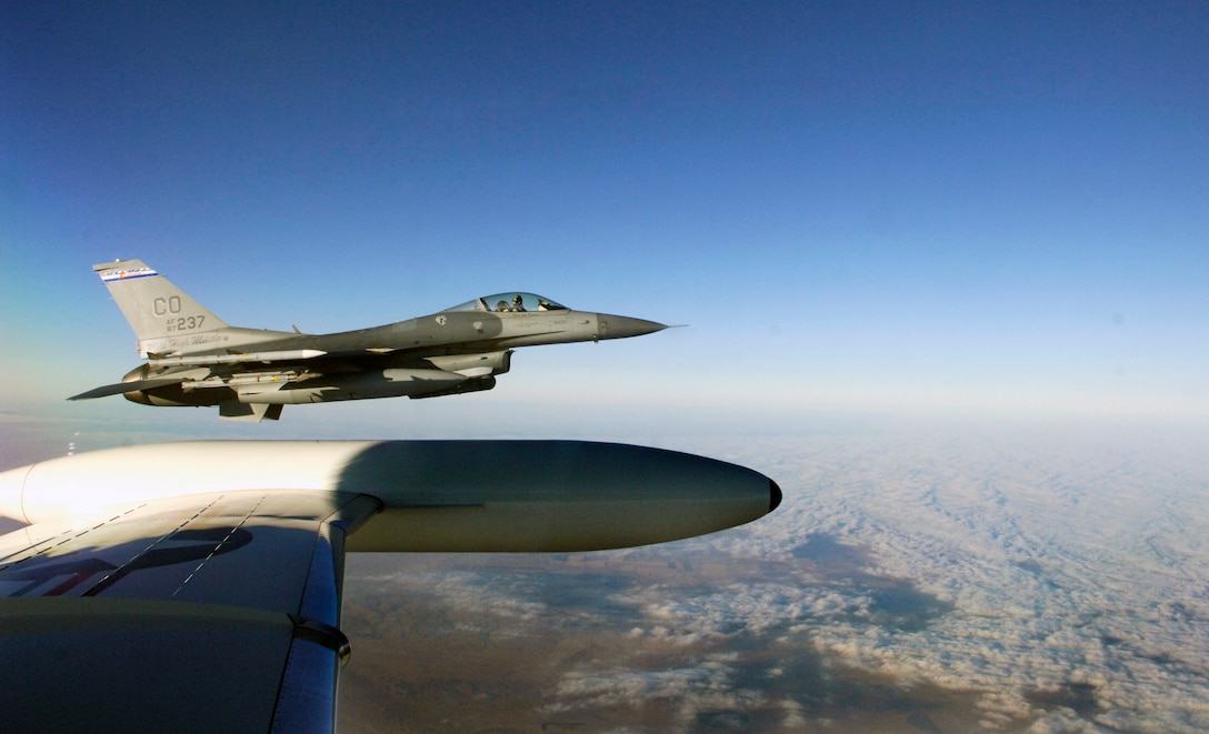 A F-16 from the 140th Fighter Wing, Buckley Air National Guard Base, CO, guides a C-21 from the 458th Airlift Squadron, Scott Air Force base, Ill Dec. 13 during Felix 12-4, a Western Air Defense Sector exercise.  The short notice exercise involved two scenarios, one where the two C-21 pilots were unconscious and another where the plane had been hijacked with no radio contact. In both scenarios the F-16 intercepted the C-21 over Colorado to guide them home. (U.S. Air Force photo/ Staff Sgt. Stephenie Wade)