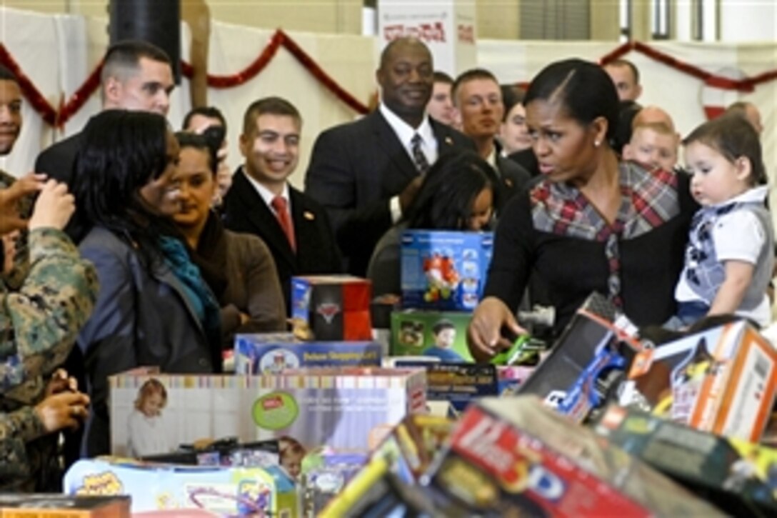 First Lady Michelle Obama holds the child of a service member during a “Toys for Tots” event on Joint Base Anacostia-Bolling in Washington, D.C., Dec. 16. The first lady and Marines sorted through toys collected from the White House staff as part of the 60-year old program’s tradition.