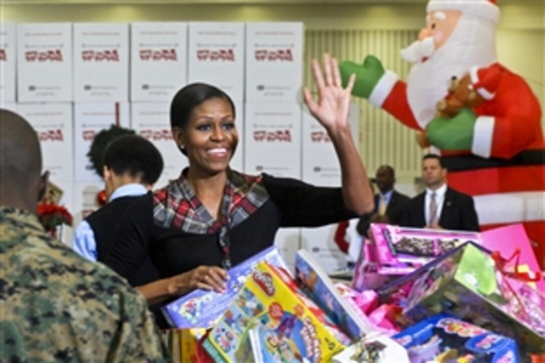 First Lady Michelle Obama waves to military family members during a Toys for Tots event with U.S. Marines on Joint Base Anacostia-Bolling, Washington, D.C., Dec. 16. The first lady and Marines sorted through toys collected from the White House staff.