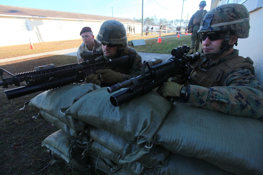 Marines with the 24th Marine Expeditionary Unit stand security alongside a role player at a notional American Embassy during a Non-Combatant Evacuation Operation training scenario as part of the Composite Training Unit Exercise (COMPTUEX), Dec. 16.  The operation, called NEO for short, is meant to evacuate American citizens and other authorized personnel from a country in turmoil.  The 24th MEU just completed COMPTUEX, which took place Nov. 28 to Dec. 20. The training served to develop cohesion between the 24th MEU and Amphibious Squadron 8 (PHIBRON 8) in conducting amphibious operations, crisis response, and limited contingency operations while operating from the sea.