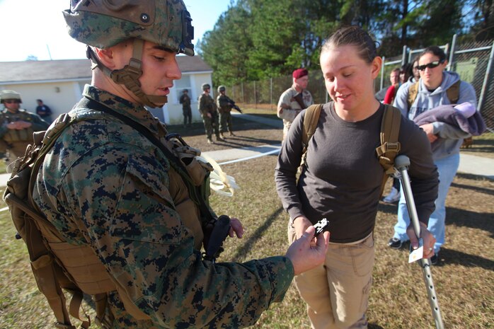 Cpl. Michael Paul, a military police officer with Combat Logistics Battalion 24, 24th Marine Expeditionary Unit confiscates a knife from a role player during a Non-Combatant Evacuation Operation training scenario as part of the Composite Training Unit Exercise (COMPTUEX), Dec. 16.  The operation, called NEO for short, is meant to evacuate American citizens and other authorized personnel from a country in turmoil.  The 24th MEU just completed COMPTUEX, which took place Nov. 28 to Dec. 20. The training served to develop cohesion between the 24th MEU and Amphibious Squadron 8 (PHIBRON 8) in conducting amphibious operations, crisis response, and limited contingency operations while operating from the sea.