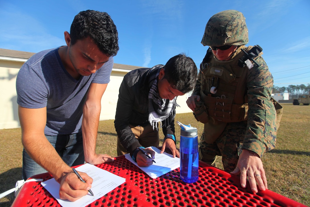 Seaman Apprentice Kevin Baggett, a hospital corpsman with Combat Logistics Battalion 24, 24th Marine Expeditionary Unit processes role players during a Non-Combatant Evacuation Operation training scenario as part of the Composite Training Unit Exercise (COMPTUEX), Dec. 16. The operation, called NEO for short, is meant to evacuate American citizens and other authorized personnel from a country in turmoil.  The 24th MEU just completed COMPTUEX, which took place Nov. 28 to Dec. 20. The training served to develop cohesion between the 24th MEU and Amphibious Squadron 8 (PHIBRON 8) in conducting amphibious operations, crisis response, and limited contingency operations while operating from the sea.