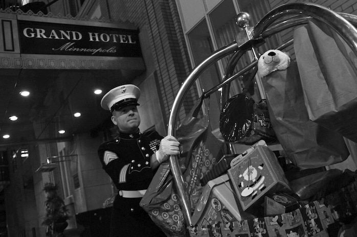 Staff Sgt. Eric M. Svedahl, 33, from Prior Lake, Minn., waits for his ride near the Grand Hotel Minneapolis entrance after picking up Christmas donations from the Molly Schaefer and Nick Johnson wedding reception Dec. 17. Instead of wedding gifts, the bride and groom asked everyone to bring a present for Toys for Tots. Overall, the newlyweds collected more than 100 donations. Svedahl is a recruiting support staff non-commissioned officer with Recruiting Station Twin Cities. For additional Toys for Tots imagery, visit www.facebook.com/rstwincities.