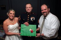 Staff Sgt. Eric M. Svedahl, 33, from Prior Lake, Minn., accepts a Christmas donation from Molly Schaefer and Nick Johnson during their wedding reception at the Grand Hotel Minneapolis Dec. 17. Instead of wedding gifts, the bride and groom asked everyone to bring a present for Toys for Tots. Overall, the newlyweds collected more than 100 donations. Svedahl is a recruiting support staff non-commissioned officer with Recruiting Station Twin Cities. For additional Toys for Tots imagery, visit www.facebook.com/rstwincities.
