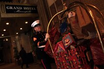 Staff Sgt. Eric M. Svedahl, 33, from Prior Lake, Minn., exits the Grand Hotel Minneapolis after picking up Christmas donations from the Molly Schaefer and Nick Johnson wedding reception Dec. 17. Instead of wedding gifts, the bride and groom asked everyone to bring a present for Toys for Tots. Overall, the newlyweds collected more than 100 donations. Svedahl is a recruiting support staff non-commissioned officer with Recruiting Station Twin Cities. For additional Toys for Tots imagery, visit www.facebook.com/rstwincities.
