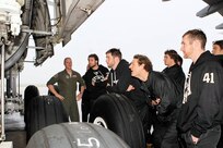 Maj. Chad Del Rossa, 433rd Airlift Wing, gives San Antonio Rampage hockey players a tour of the C-5 Galaxy Dec. 13. (U.S. Air Force photo/Antonio Morano)