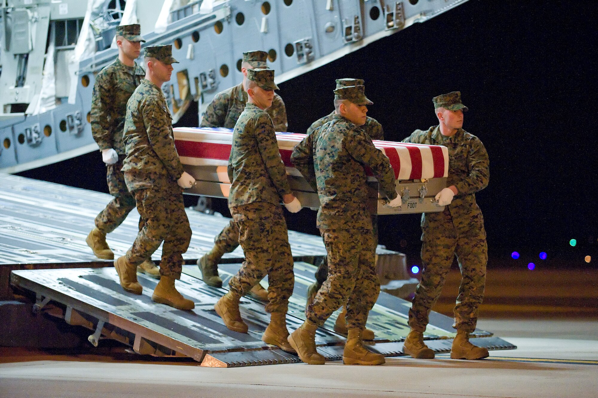 A U.S. Marine Corps carry team transfers the remains of Marine Maj. Samuel M. Griffith of Virginia Beach, Va., at Dover Air Force Base, Del., Dec. 16, 2011. Griffith was assigned to the 4th Air-Naval Gunfire Liaison Company, Marine Forces Reserve, West Palm Beach, Fla. (U.S. Air Force photo/Adrian R. Rowan)
