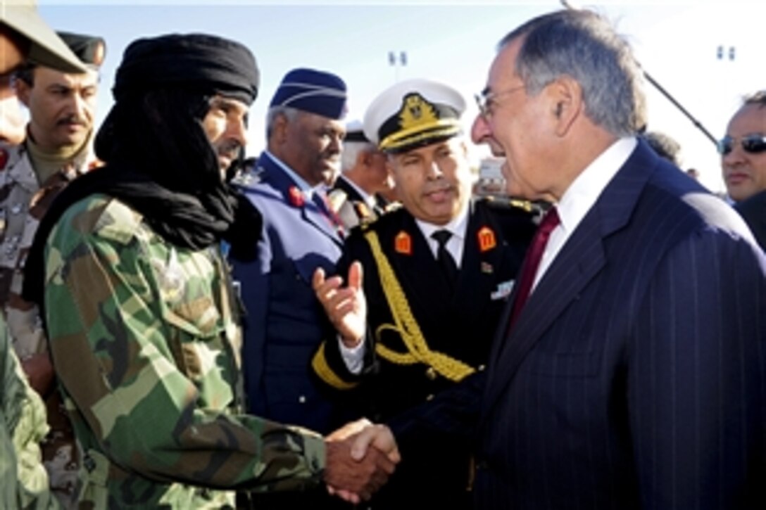 U.S. Defense Secretary Leon E. Panetta shakes hands with a Libyan freedom fighter in Tripoli, Libya, Dec.  17, 2011. 