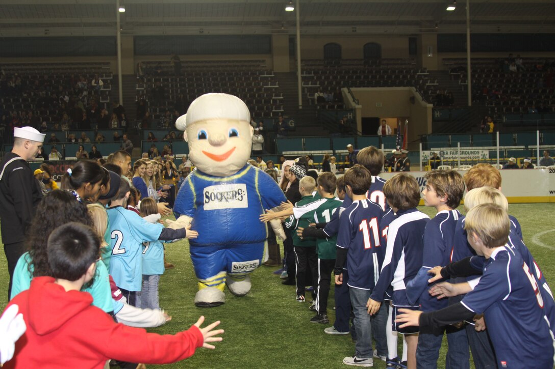 The San Diego Sockers mascot runs through a line of youth soccer players during the San Diego Sockers entrance to the field before their game against the Tacoma Stars at Del Mar Arena, Del Mar, Calif. Dec. 17. Service members looking to attend a Sockers game can purchase tickets through Ticketmaster with a military discount.