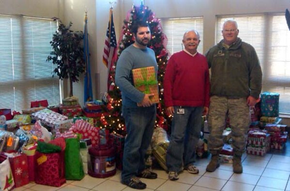 Chris Dobbs, 507th ARW student hire (left), and Lt. Col. Rich Curry, 507th ARW Public Affairs chief (right), visited and donated more than 280 gifts to the Norman, OK Veterans Center on December 16, 2011. Lt. Col. Curry presented these gifts to Mr. Glen Williams, Norman VA Center (center), on behalf of the 507th ARW, the 513th ACG, and the men and women across Tinker A.F.B. that supported the annual Angel Tree Project. 
