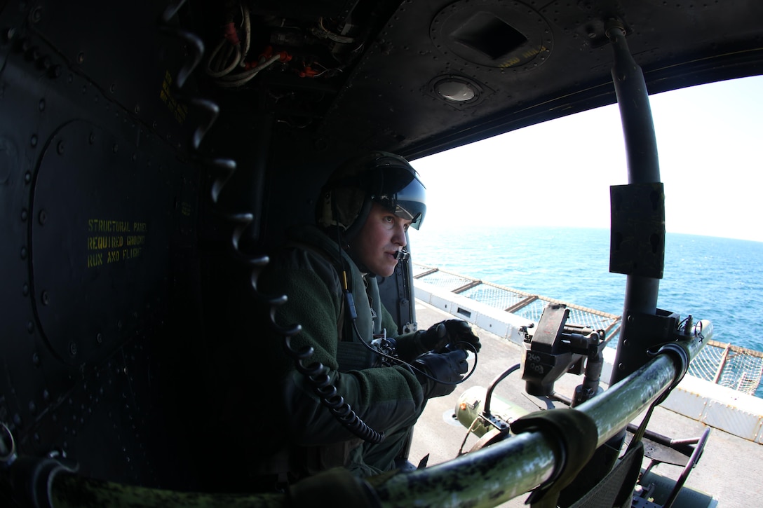 Sergeant Matthew Yoskovich, a UH-1 Huey crew chief with Marine Medium Tiltrotor Squadron VMM-261 (Rein), 24th Marine Expeditionary Unit, performs his pre-flight checks of a UH-1 Huey prior to departing the USS New York, (LPD-21) off the coast of Camp Lejeune, N.C., Dec. 18, 2011. The training was part of the Composite Training Unit Exercise (COMPTUEX), the second at-sea training period for 24th MEU, scheduled to take place Nov. 28 to Dec. 21. The training is meant to develop cohesion between the 24th MEU and Amphibious Squadron 8 (PHIBRON 8) in conducting amphibious operations, crisis response, and limited contingency operations while operating from the sea.