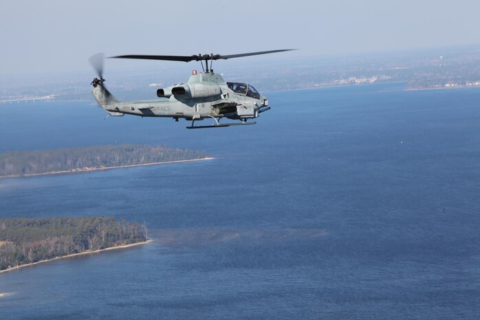 An AH-1 Super Cobra, with Marine Medium Tiltrotor Squadron VMM-261 (Rein), 24th Marine Expeditionary Unit, flies to its objective in support of an amphibious assault during a training exercise aboard Camp Lejeune, N.C., Dec. 18, 2011. The training was part of the Composite Training Unit Exercise (COMPTUEX), the second at-sea training period for 24th MEU, scheduled to take place Nov. 28 to Dec. 21. The training is meant to develop cohesion between the 24th MEU and Amphibious Squadron 8 (PHIBRON 8) in conducting amphibious operations, crisis response, and limited contingency operations while operating from the sea.