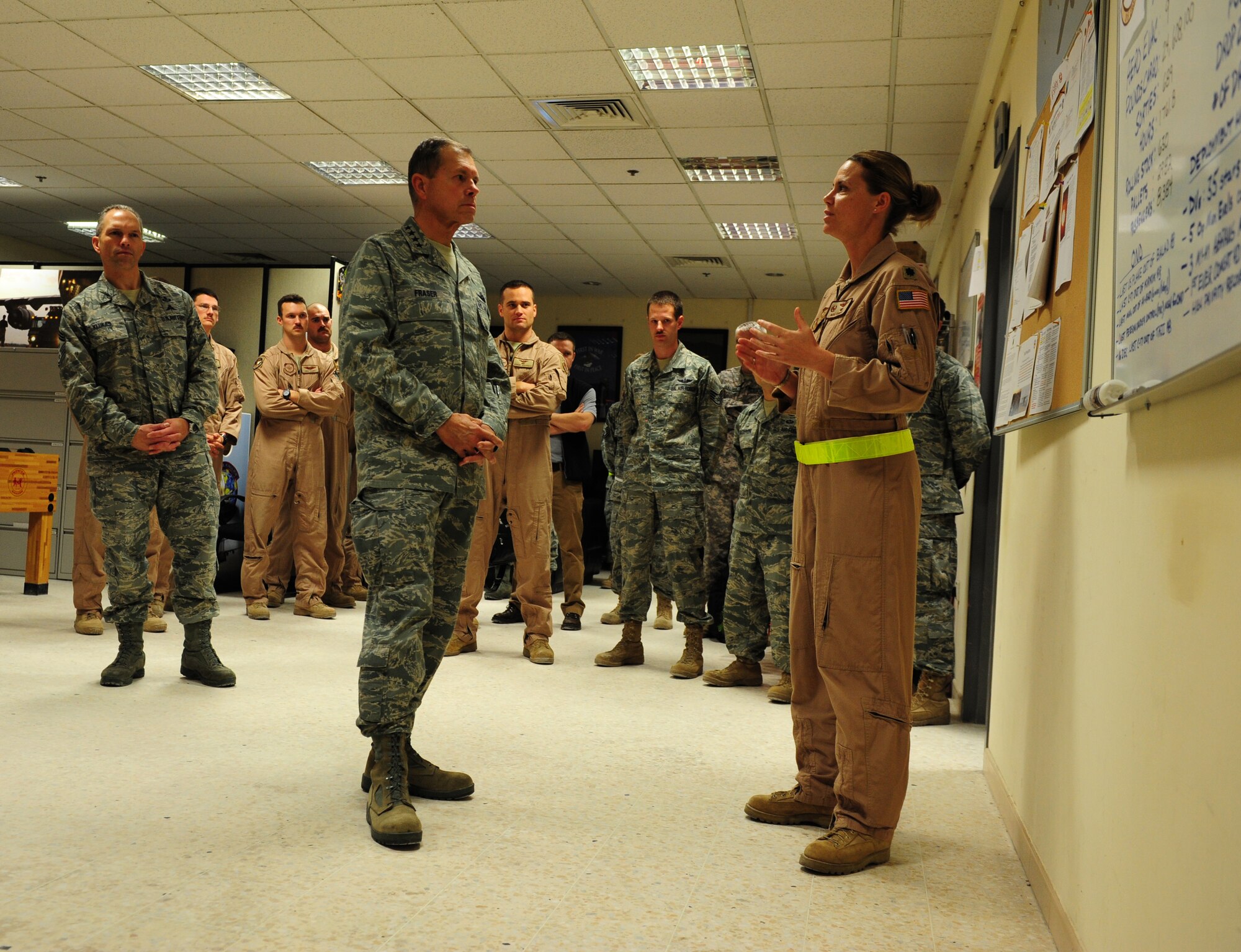 SOUTHWEST ASIA – Lt. Col. Rebecca Sonkiss, 816th Expeditionary Airlift Squadron commander, explains the many missions the 816th EAS carries out on a daily basis to U.S. Air Force Gen. William M. Fraser III, U.S. Transportation Command commander, during his visit to an undisclosed location in Southwest Asia Dec. 16.  The 816th EAS, equipped with the C-17 Globemaster III, provides airlift, airdrop and aeromedical evacuation capabilities. (U.S. Air Force photo/Staff Sgt. Nathanael Callon)