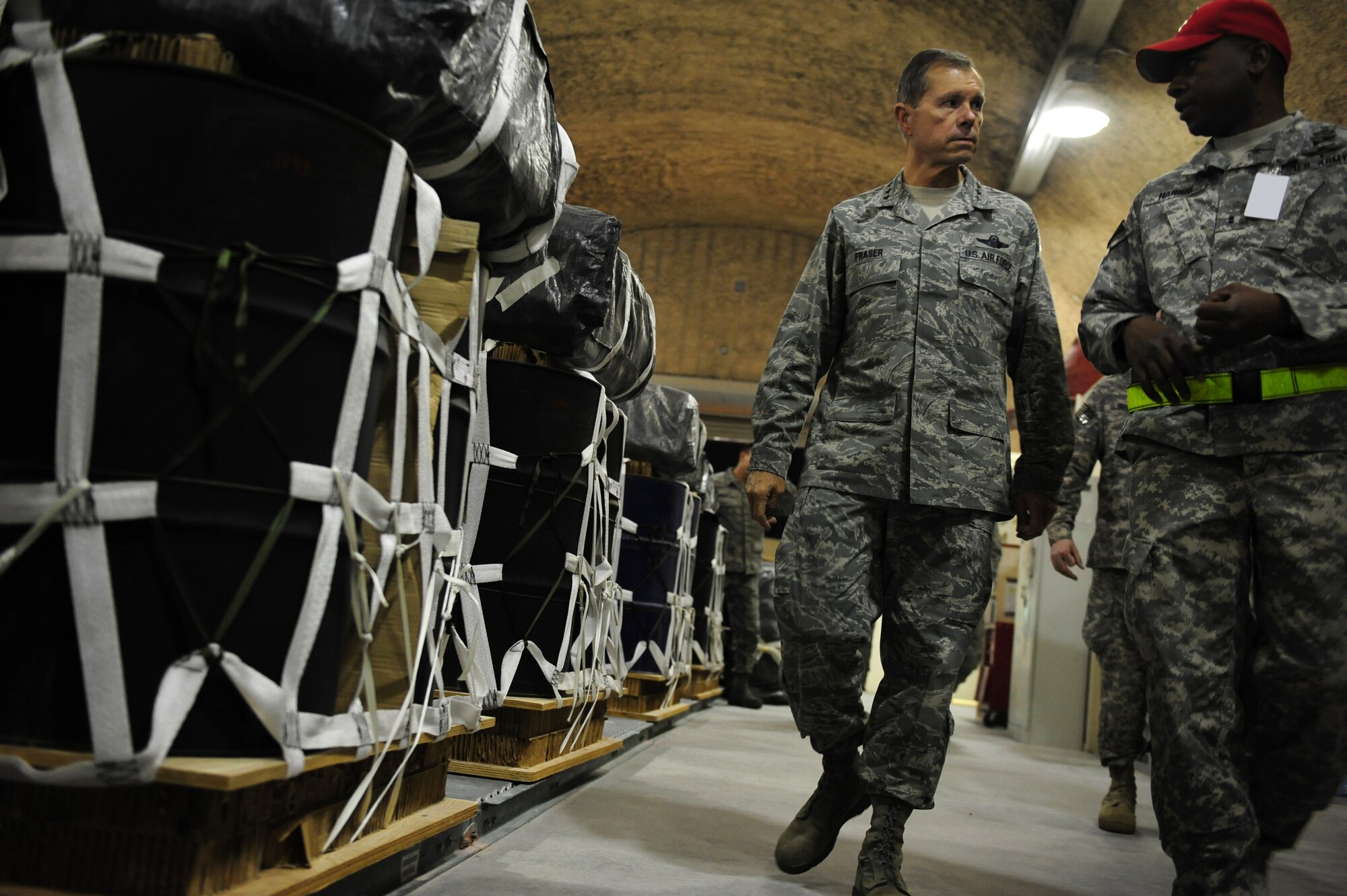 SOUTHWEST ASIA – U.S. Army Chief Warrant Officer 2 John Harris, 421st Quartermaster Company Parachute Riggers senior airdrop system technician, explains the Army Riggers' relationship with the 8th Expeditionary Air Mobility Squadron to U.S. Air Force Gen. William M. Fraser III, U.S. Transportation Command commander, during Fraser's visit to an undisclosed location in Southwest Asia Dec. 16. Fraser visited with Airmen and expressed his thanks for their service during the holiday season during his first visit to the 379th Air Expeditionary Wing since he became USTRANSCOM commander in October. (U.S. Air Force photo/Staff Sgt. Nathanael Callon)