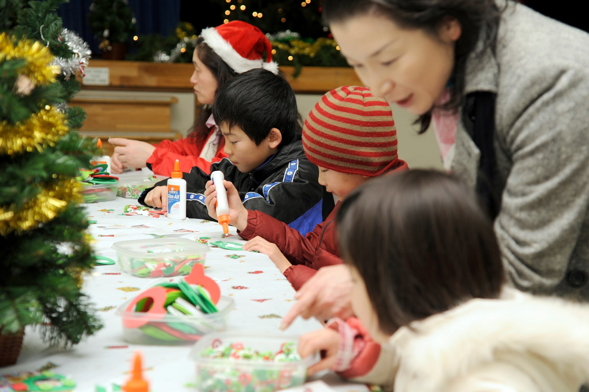 MISAWA AIR BASE, Japan - Japanese children from the local community decorate ornaments during the Misawa Holiday Lights Tour here, Dec. 17. The tour ended with a celebration at Sollars Elementary School where guests enjoyed hot chocolate and cookies, and children enjoyed arts and crafts and met Santa Claus. (U.S. Air Force photo/Tech. Sgt. Marie Brown)