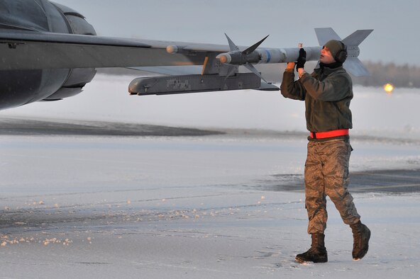 U.S. Air Force Senior Airman Joseph Levin inspects an AIM-9 training missile affixed to an F-16 Fighting Falcon during an end of runway inspection Dec. 19, 2011, Eielson Air Force Base, Alaska. The inspection occurs prior to take off and ensures the aircraft is prepared to fly. Levin is a weapons load crew member assigned to the 354th Aircraft Maintenance Squadron. (U.S. Air Force photo by Staff Sgt. Christopher Boitz/Released)