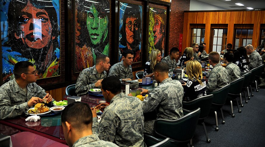 U.S. Air Force Airmen from the 18th Wing have lunch with the Dallas Cowboys Cheerleaders at the Marshall Dining Facility Dec. 15, 2011 at Kadena Air Base, Japan. The Cowboys Cheerleaders toured the base and performed a show at the Keystone theater Dec. 15 and 16. (U.S. Air Force photo by Staff Sgt. Christopher Hummel/Released) 
