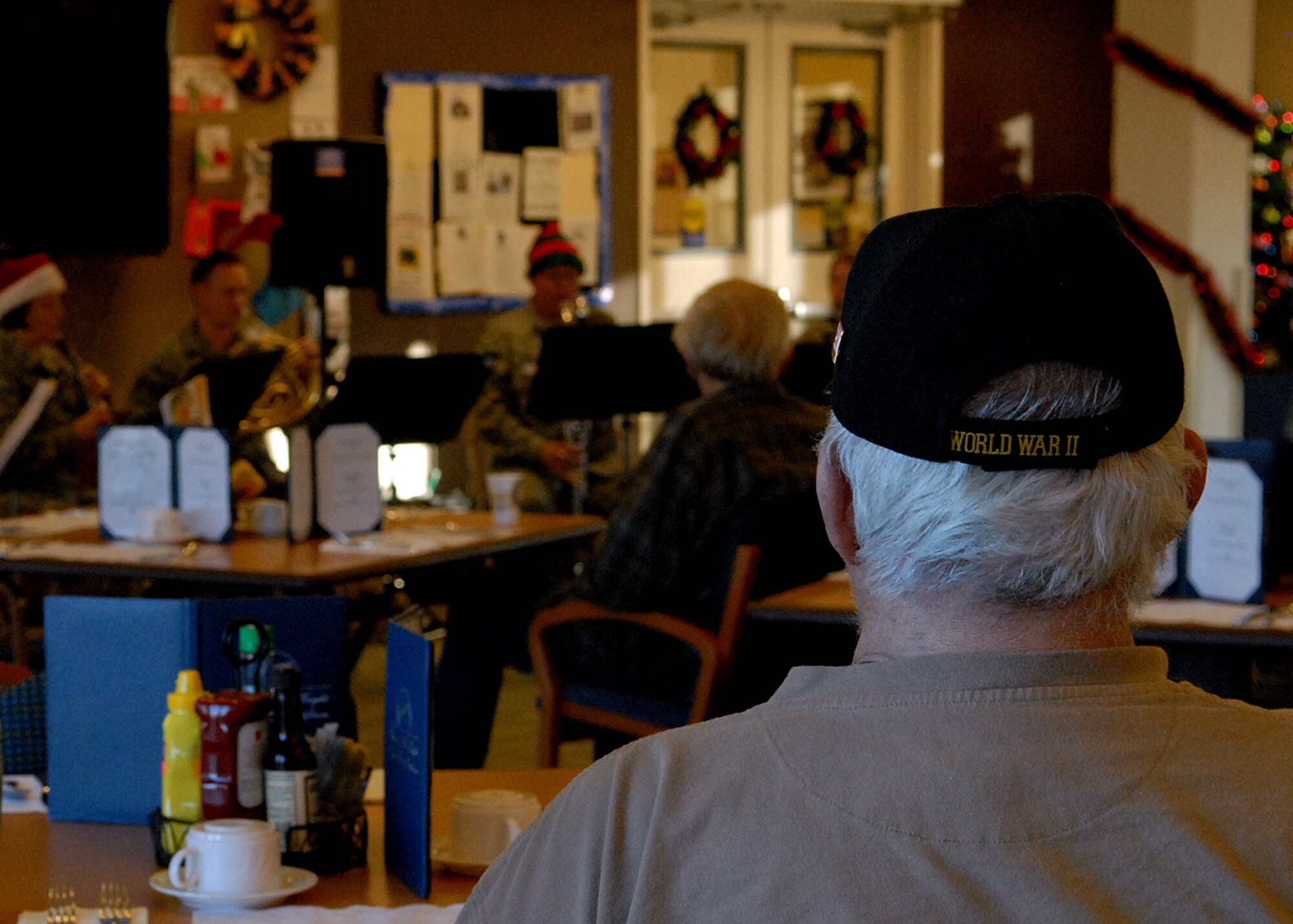 A resident of the William J. “Pete” Knight Veterans Home of California in Lancaster looks on as The Golden West Winds play their last show of the day, Dec. 14. (U.S. Air Force photo by Melissa Buchanan)