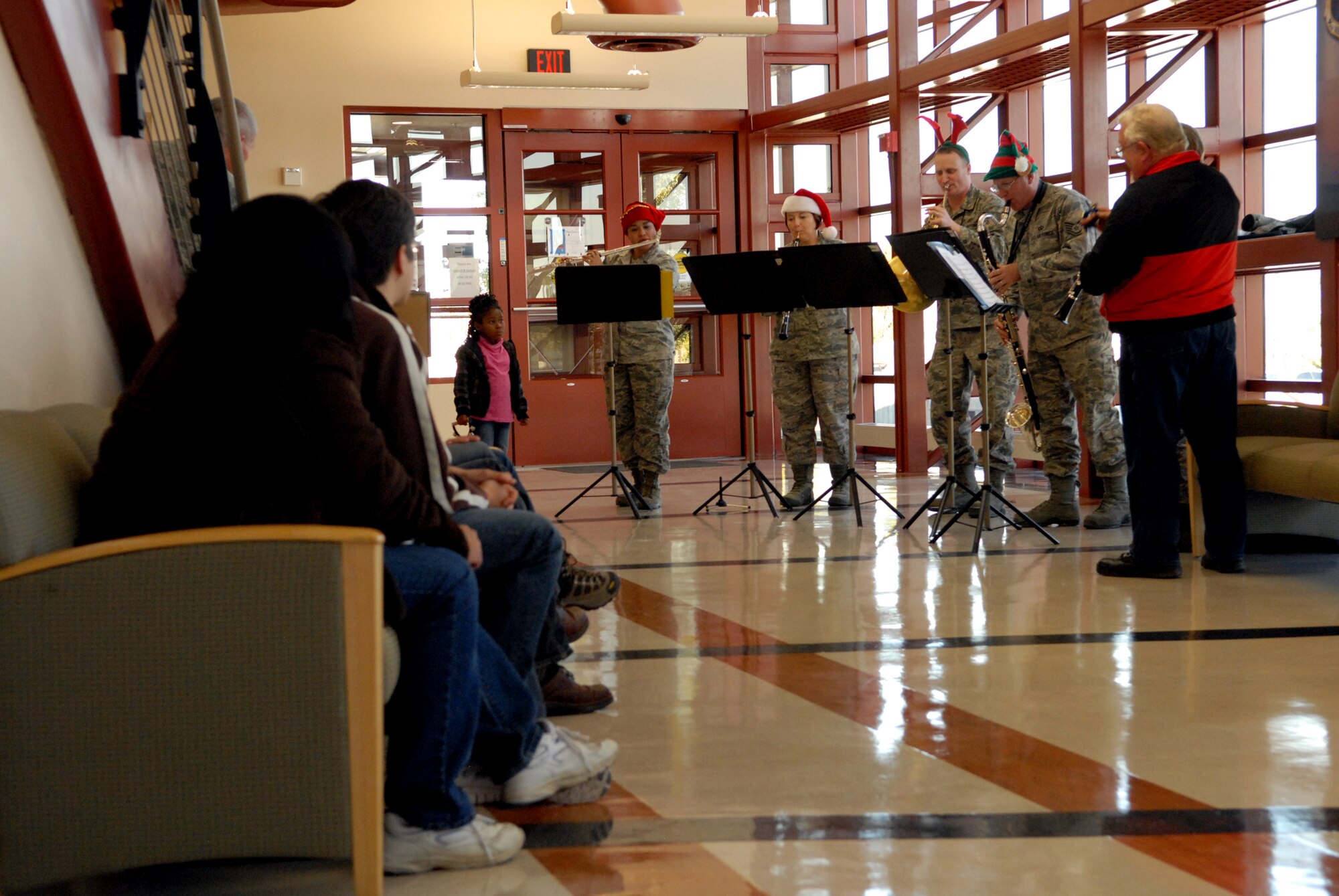Personnel in the Medical Clinic gather to listen to holiday carols, Dec. 14.  
(U.S. Air Force photo by Melissa Buchanan)
