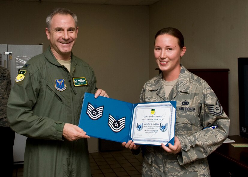 Col. Tim Fay, 2nd Bomb Wing commander, presents Staff Sgt. Jennifer LeBlanc, 2nd Logistics Readiness Squadron, with her new technical sergeant stripes Dec. 14 as part of the Stripes For Exceptional Performers program on Barksdale Air Force Base, La. STEP is an incentive program that identifies outstanding senior airmen, staff sergeants and technical sergeants for immediate promotion and is based on the Airman's professional accomplishments and commander recommendations. (U.S. Air Force photo/Airman 1st Class Ben Gonsier)(RELEASED)