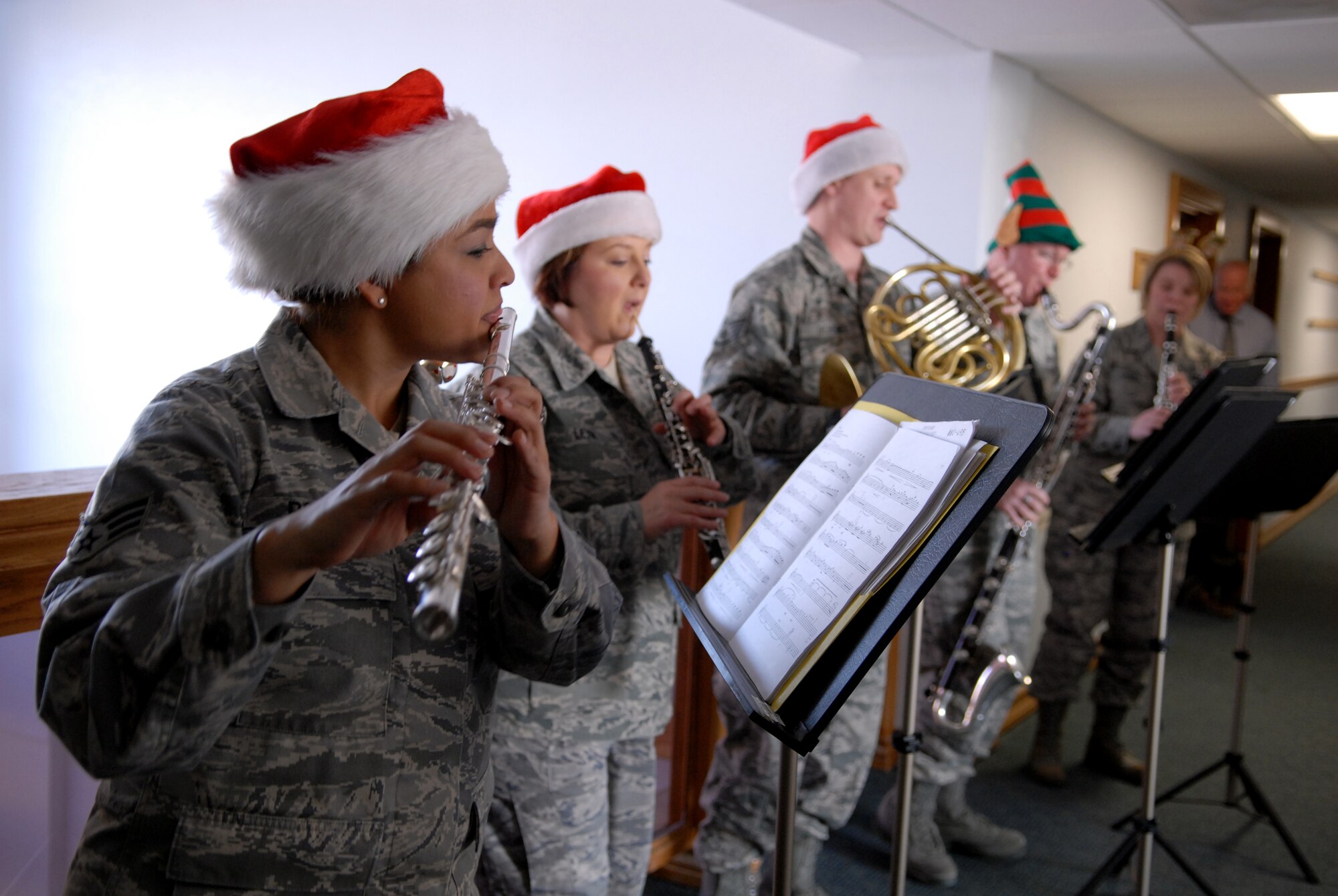 Senior Airman Melissa Rocha plays holiday tunes with her Golden West Winds band mates – from left Tech. Sgt. Coreen Levin, oboe; Staff Sgt. Ed Ochsner, horn; Tech. Sgt. Mark Craig, bass clarinet; and Tech Sgt. Anna Andrew, clarinet -- in Bldg. 1, Dec. 14. The quintet visited Edwards to spread holiday cheer in the form of seasonal favorites. Personnel were invited to central locations in several buildings to sing along to the music. (U.S. Air Force photo by Melissa Buchanan) 