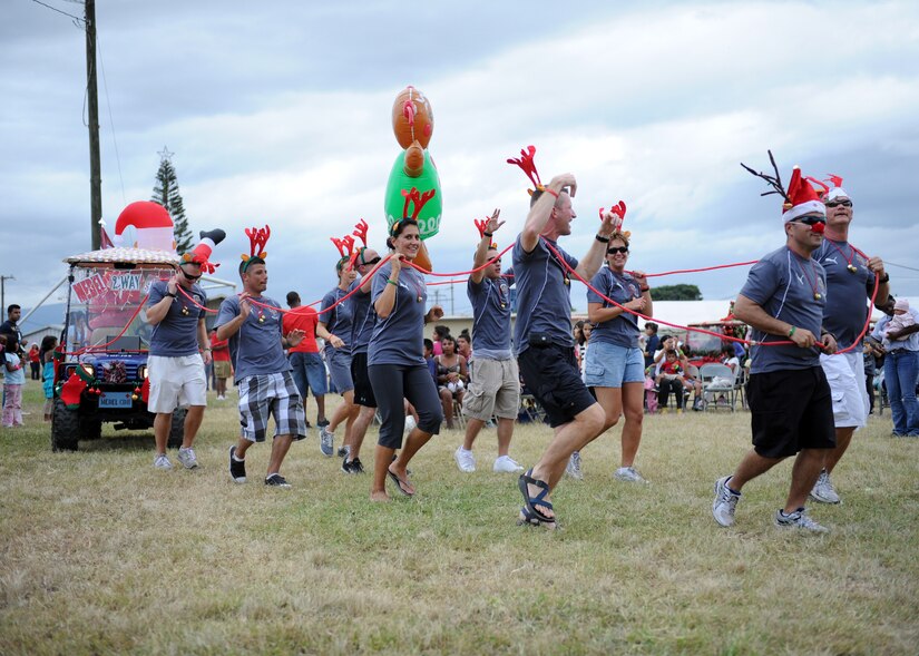 The Joint Task Force-Bravo’s Medical Element parade through the crowd showing of their Ez-Go float carrying Santa and his elf pulled by “reindeer” Dec. 15 during the Holiday Extravaganza at Soto Cano AB, Honduras. The Holiday Extravaganza was a first for Team Soto Cano and required support from all agencies to successfully bring holiday cheer to more than 700 participants. (Air Force photo by Master Sgt. Michael Atkins)