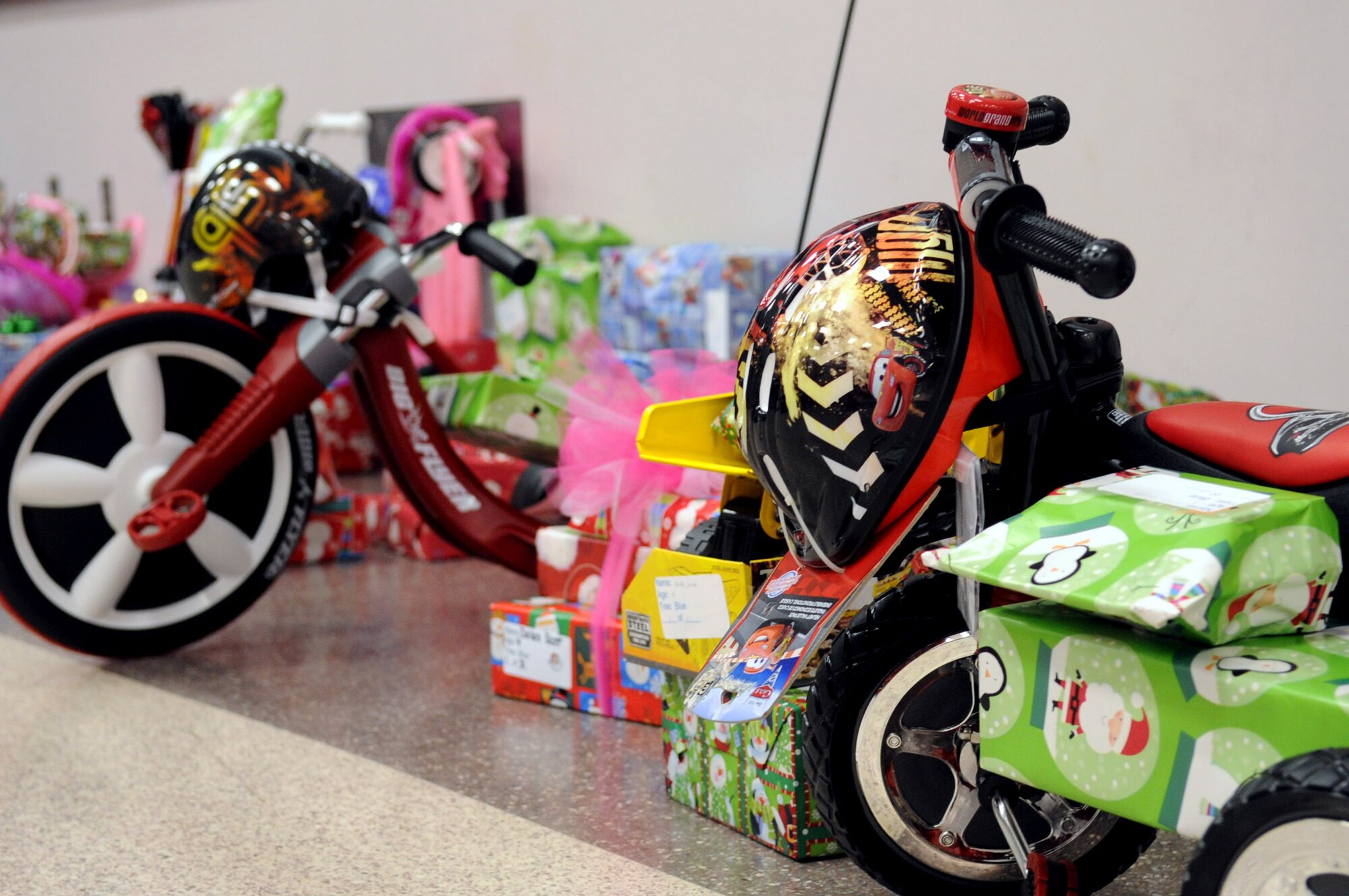 BARKSDALE AIR FORCE BASE, La. -- Toys and wrapped gifts line a wall during Barksdale's Santas in Blue Christmas party held at the Bossier City Civic Center in Bossier City, La., Dec. 17. The SIB committee raised more than $12,000 and purchased more than 600 gifts for local foster children. (U.S. Air Force photo/Senior Airman La'Shanette V. Garrett)(RELEASED)