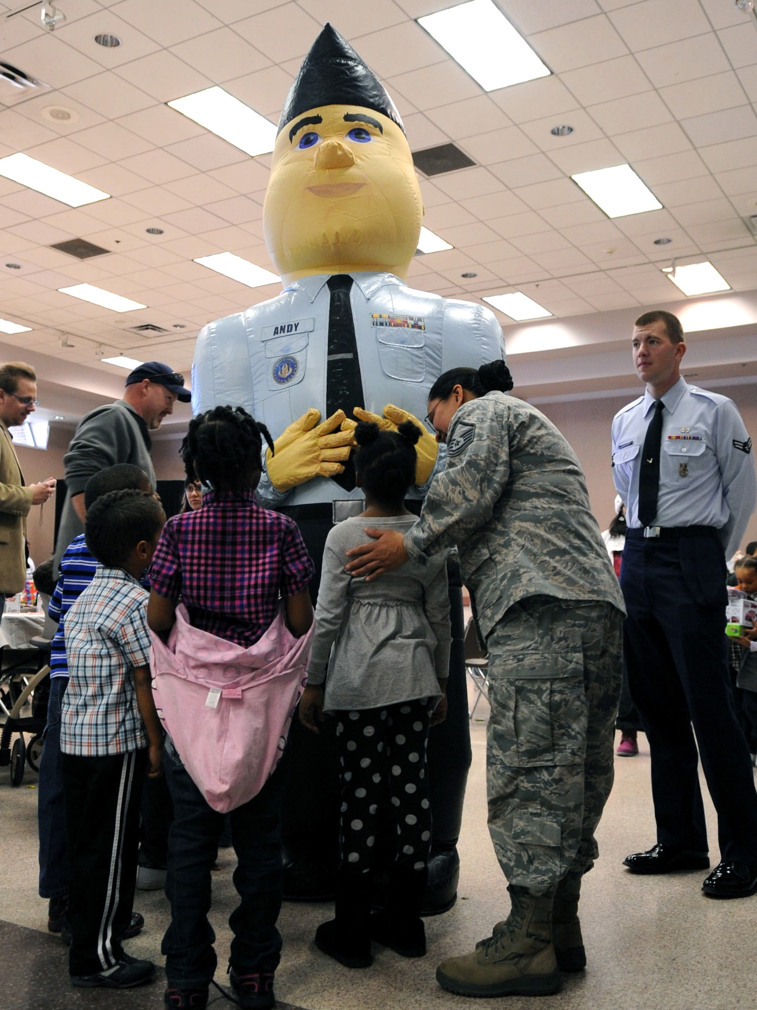 BARKSDALE AIR FORCE BASE, La. - Children crowd around Airman Andy during Barksdale's Santas in Blue Christmas party held at the Bossier City Civic Center in Bossier City, La., Dec. 17. More than 400 people attended the event held for local foster children. (U.S. Air Force photo/Senior Airman La'Shanette V. Garrett)(RELEASED)