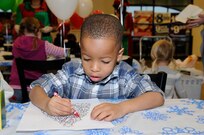 Monty Alexander colors a holiday picture during the festivities at Breakfast with Santa Dec. 10.(U.S. Air Force photo/Don Lindsay)