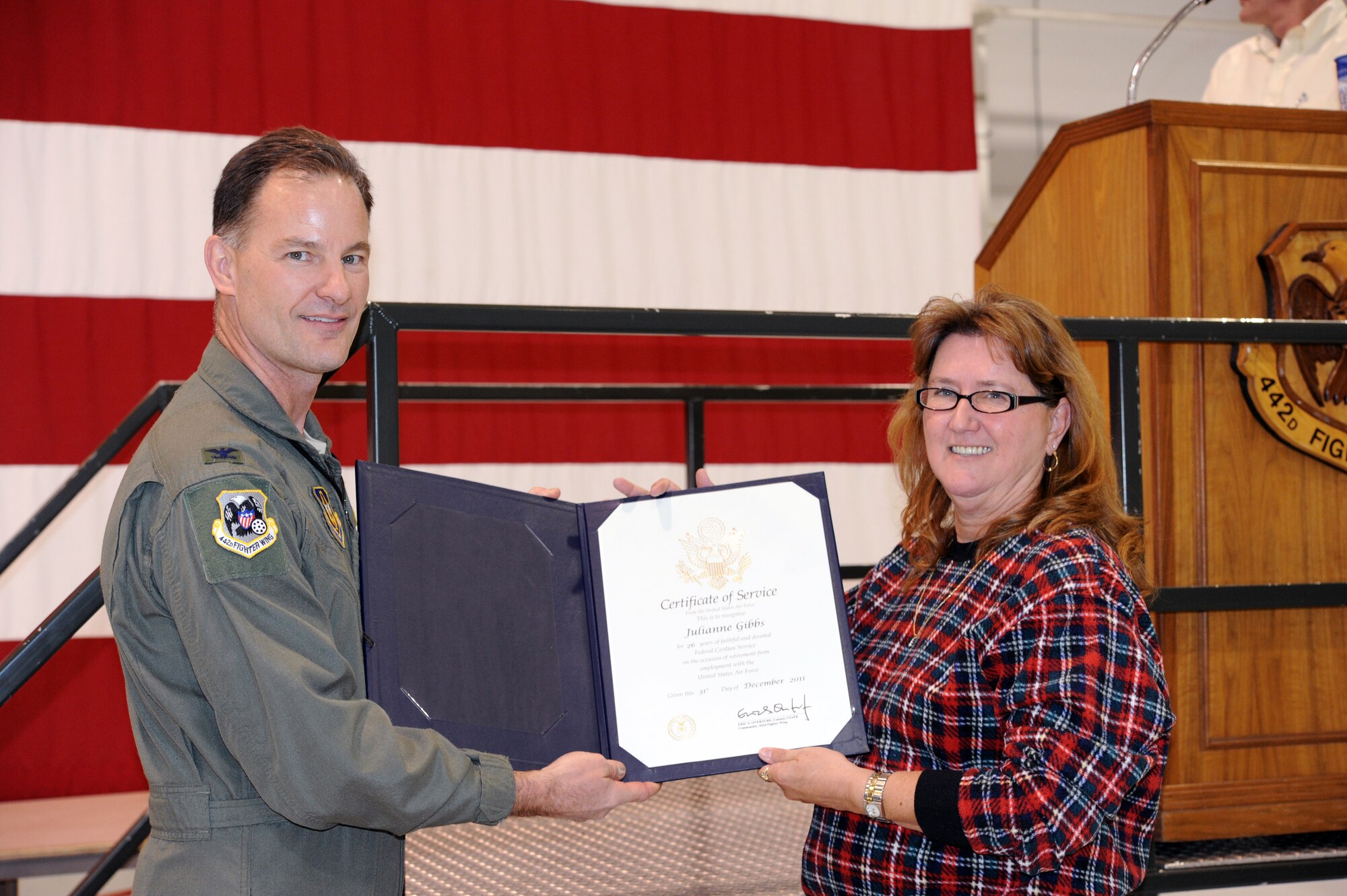Julie Gibbs, 442nd Fighter Wing financial manager, receives a Certificate of Service for serving 26 years as a civilian for the federal government. Gibbs accepted the award from Col. Eric S. Overturf 442nd Fighter Wing commander, at the civilian Christmas party, Dec. 15. The civilian Christmas party is a morale event for civilians and air reserve technicians in the 442nd Fighter Wing, an A-10 Thunderbolt II Air Force Reserve unit at Whiteman Air Force Base, Mo. (U.S. Air Force photo/Staff Sgt. Danielle Wolf)